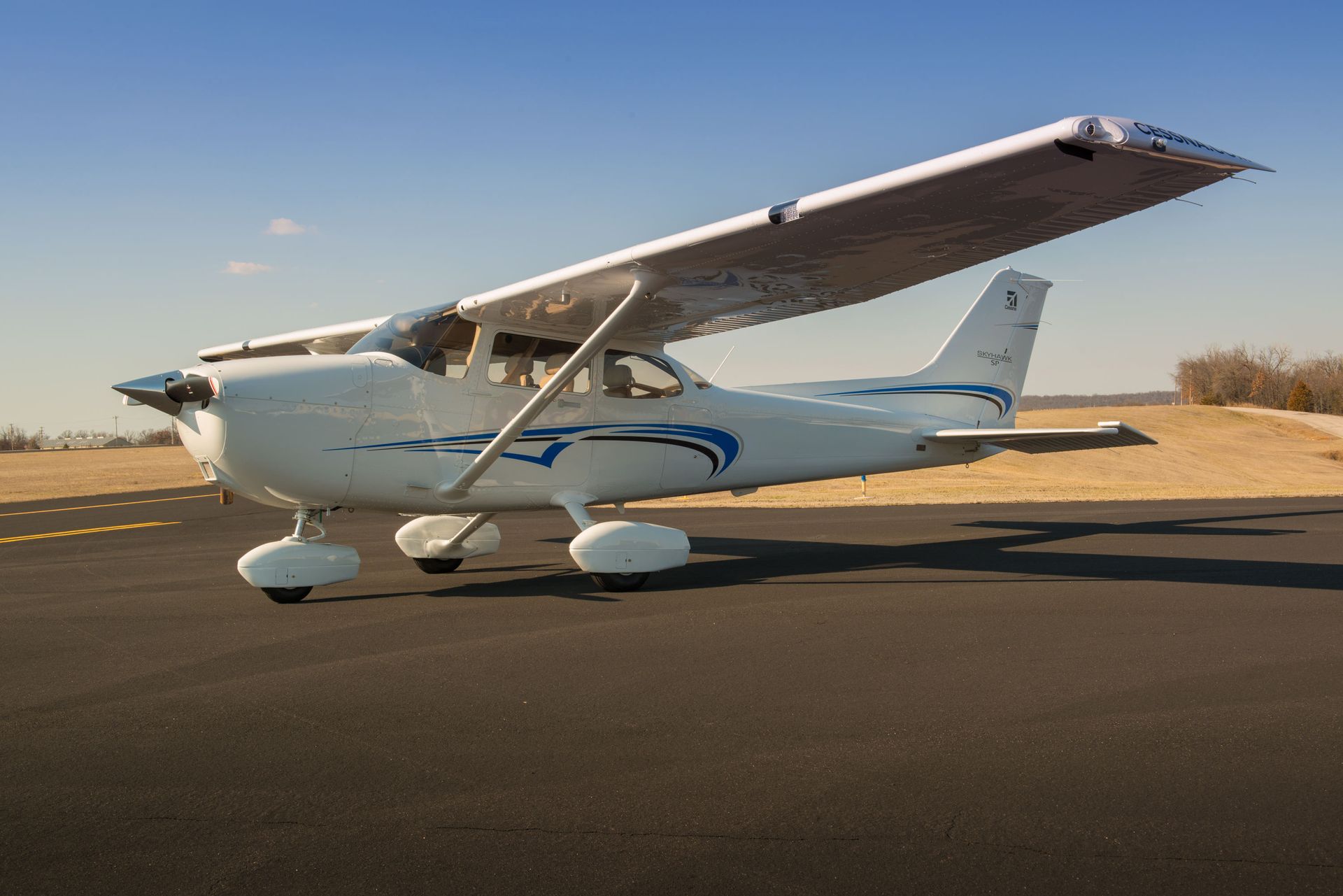 A small propeller plane is parked on the runway.