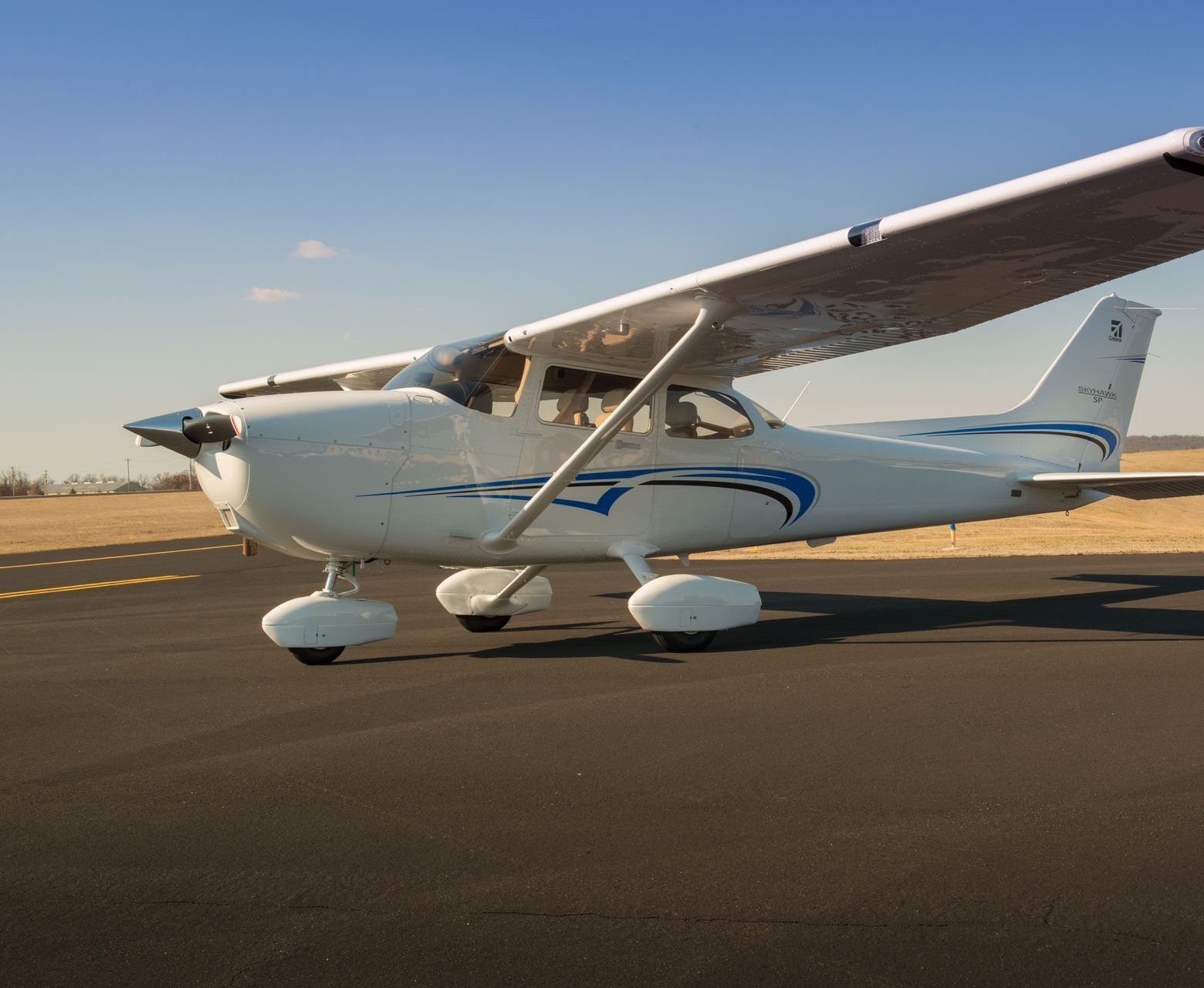 A small propeller plane is parked on the runway.