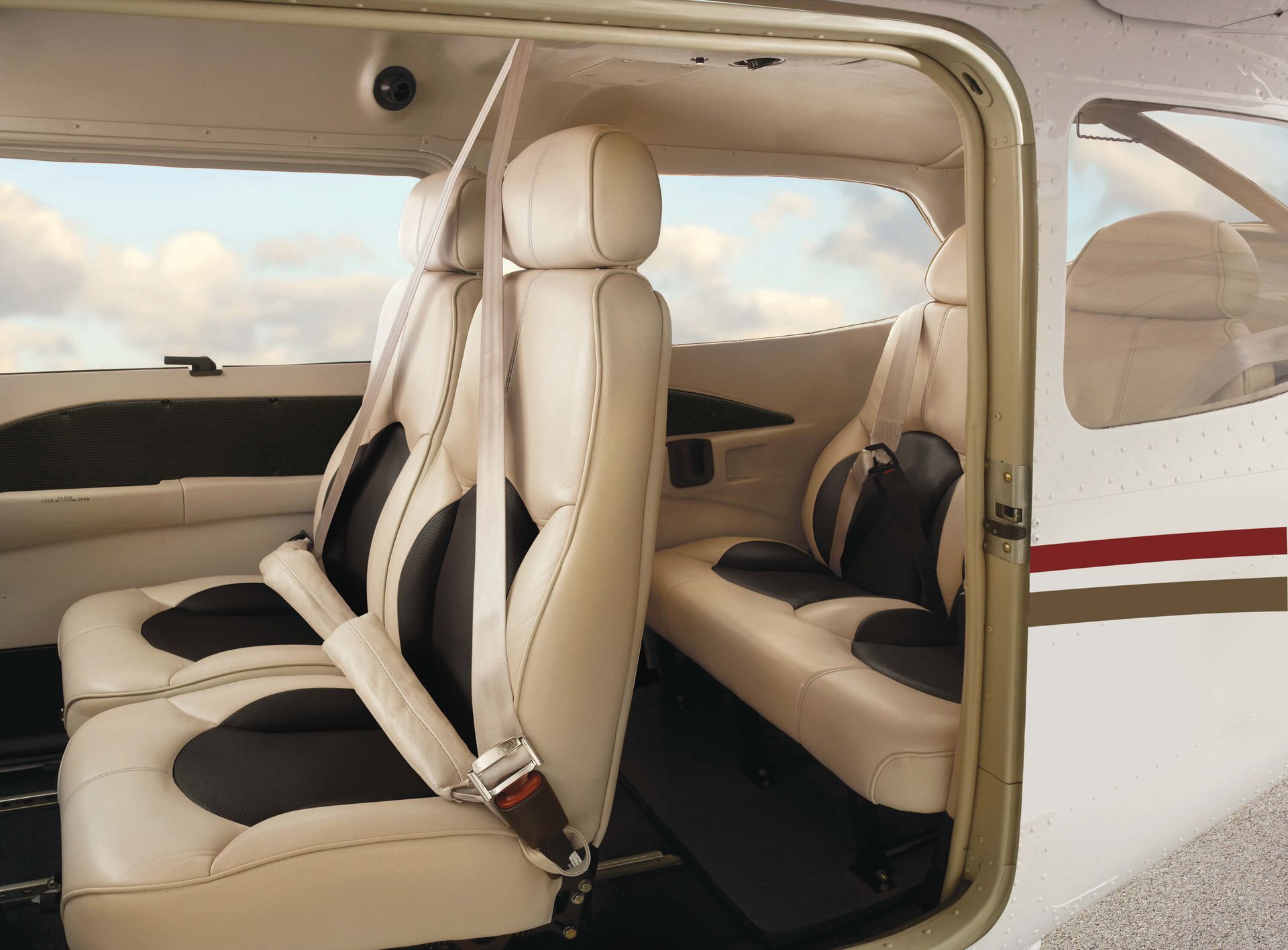 The inside of a small airplane with the door open