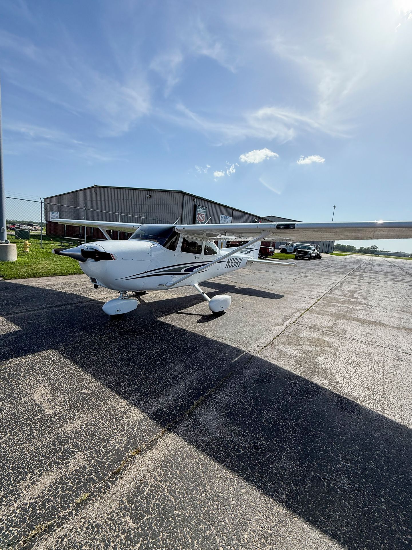 A small propeller plane is parked on a runway.