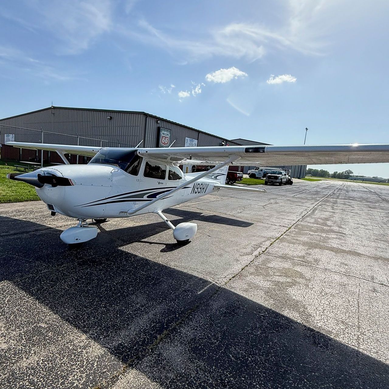 A small propeller plane is parked on a runway.