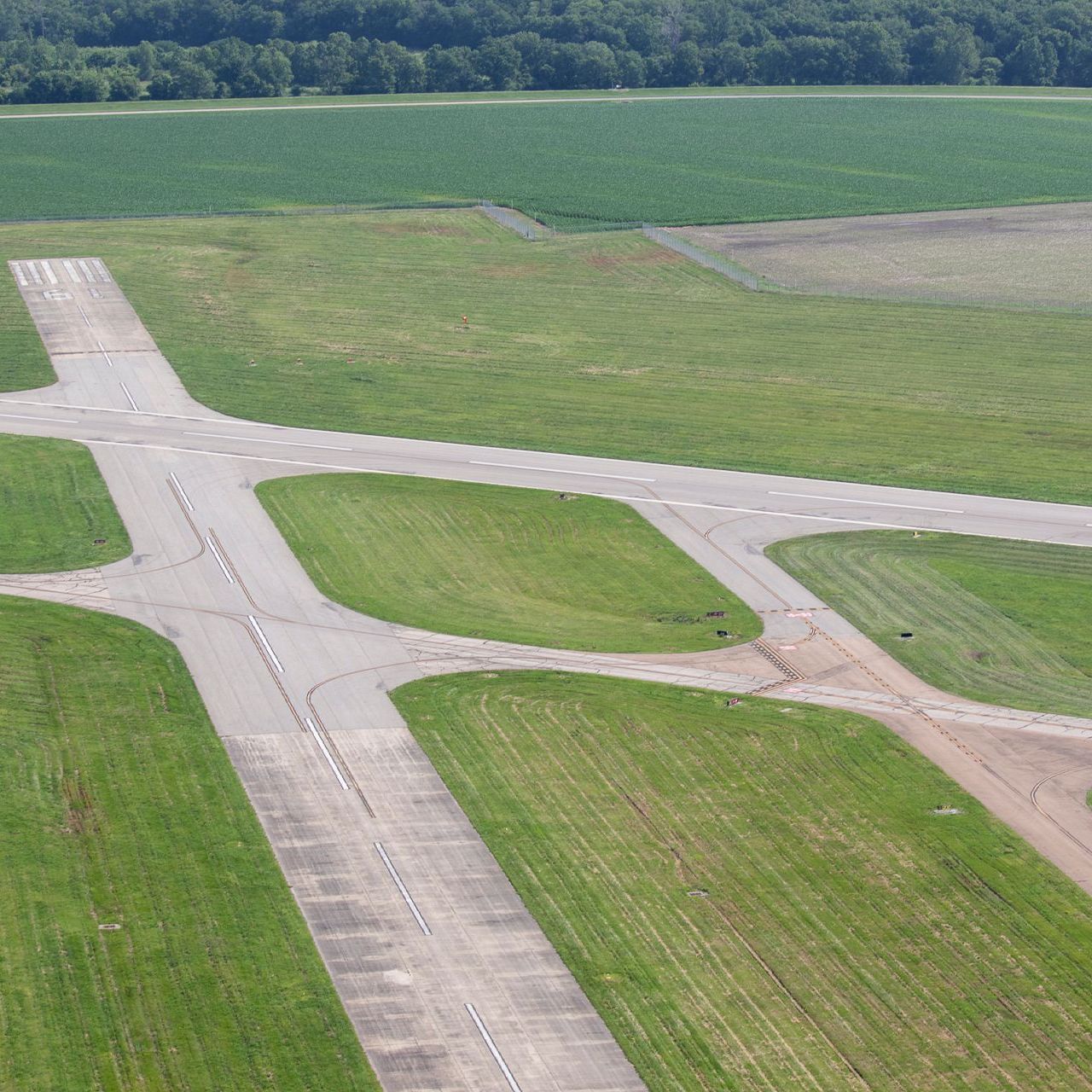 A small white airplane is sitting on a runway.