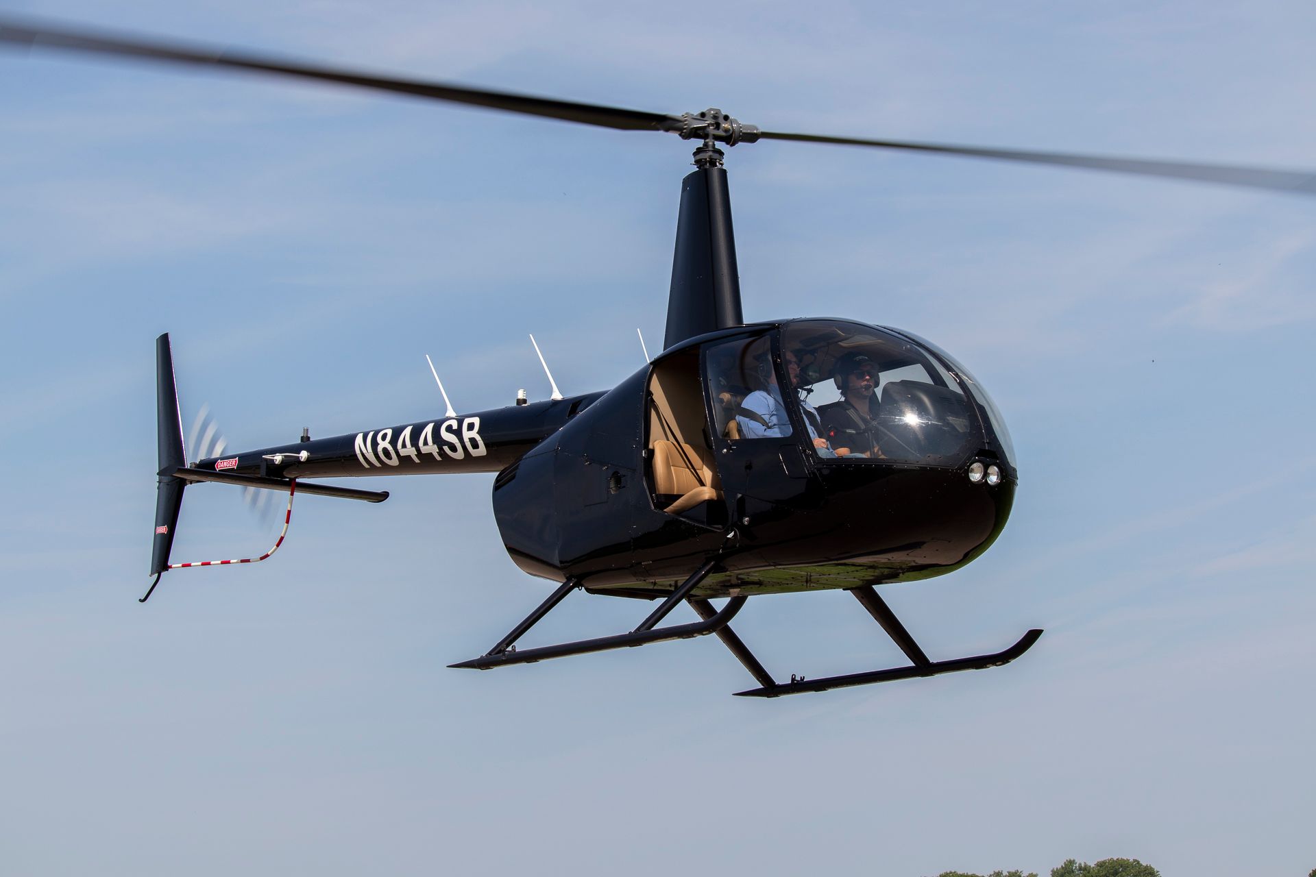 A small private jet is parked on the tarmac at an airport.