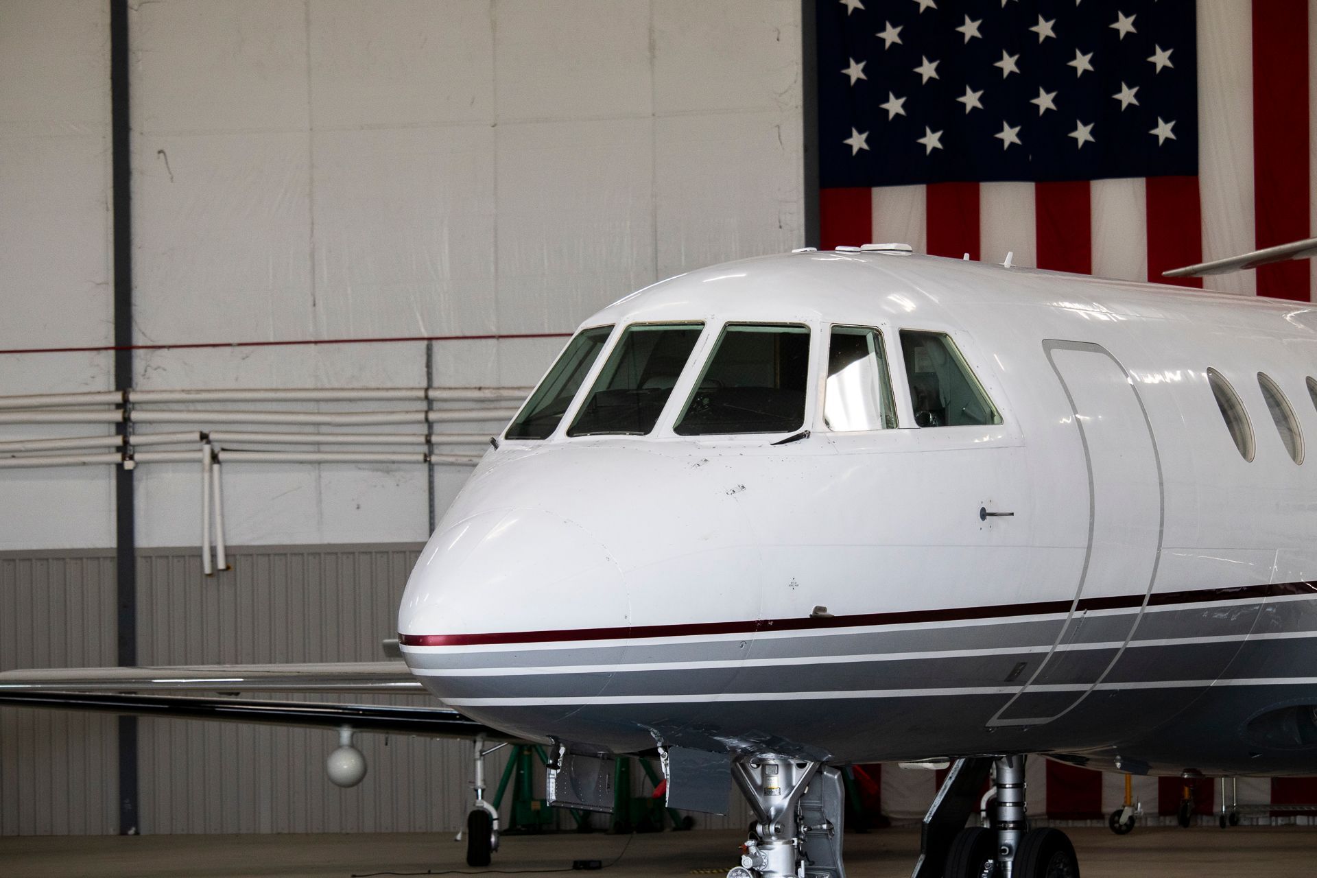 A small propeller plane is parked in a hangar