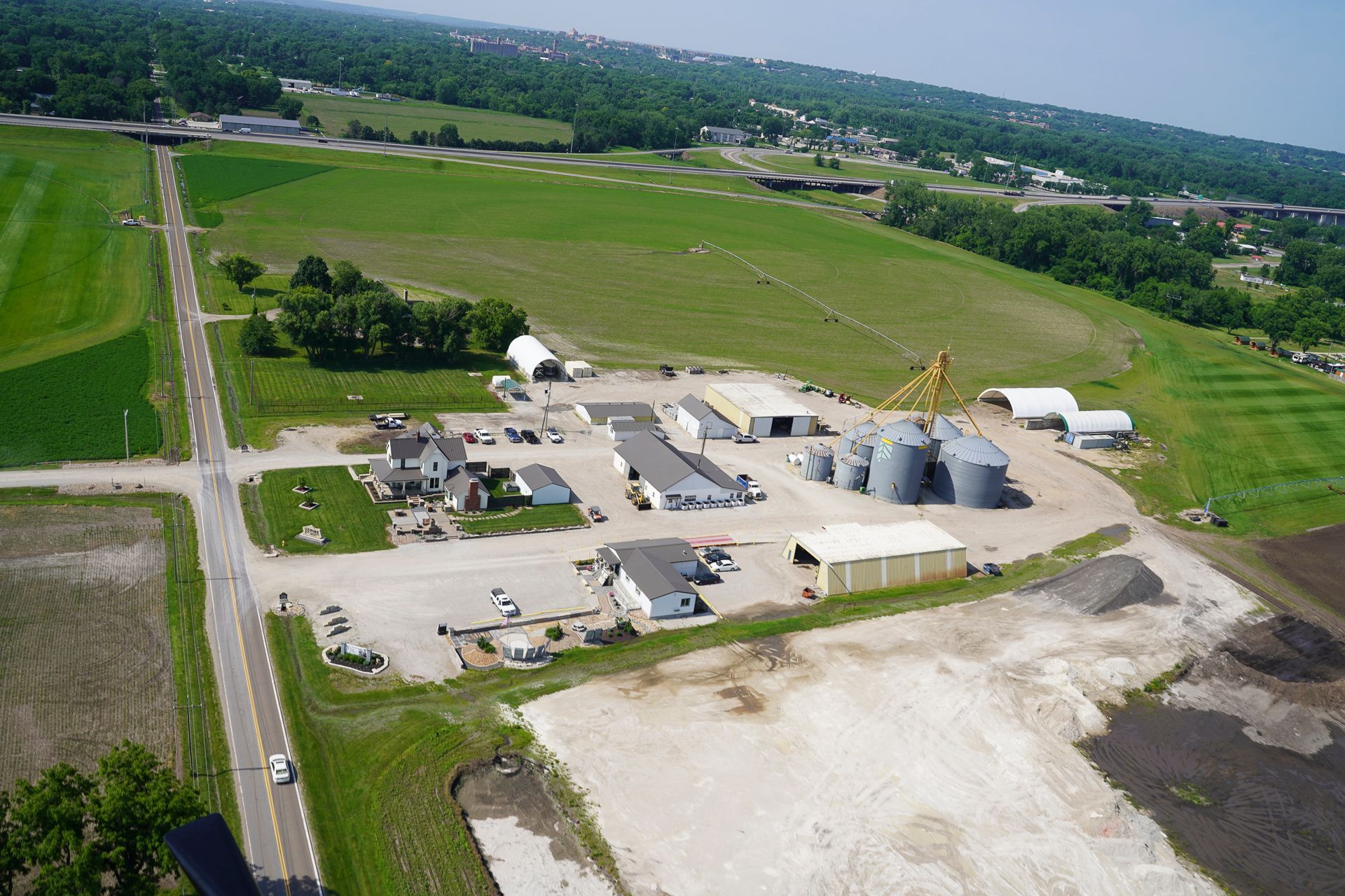 An aerial view of a farm with a lot of buildings and silos