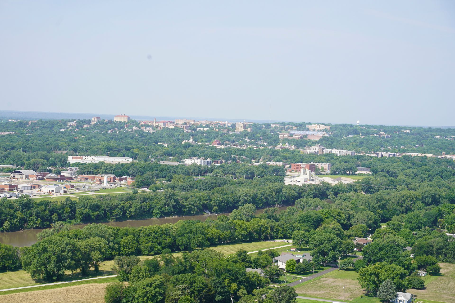 An aerial view of a city surrounded by trees