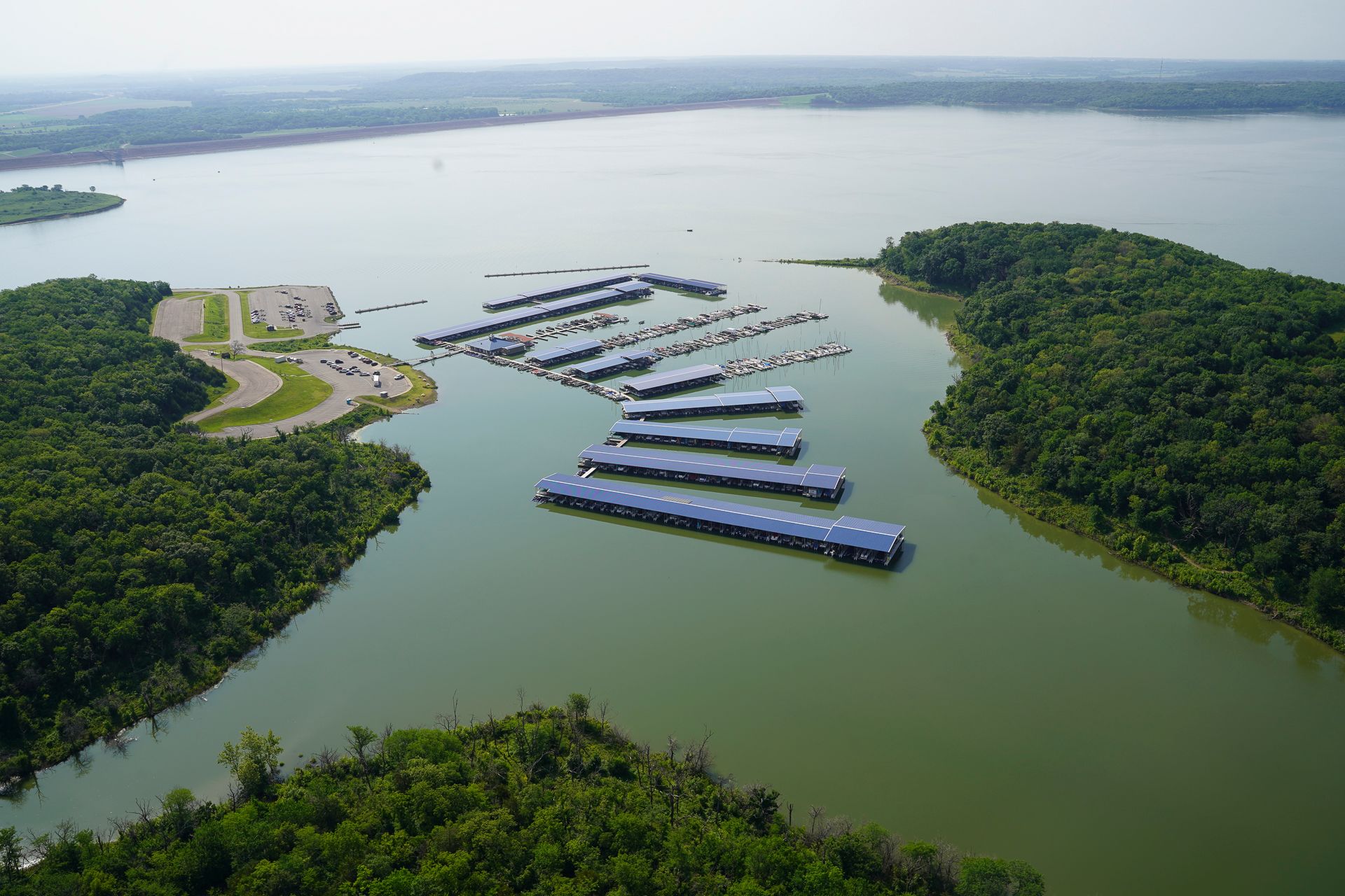 An aerial view of a large body of water surrounded by trees.