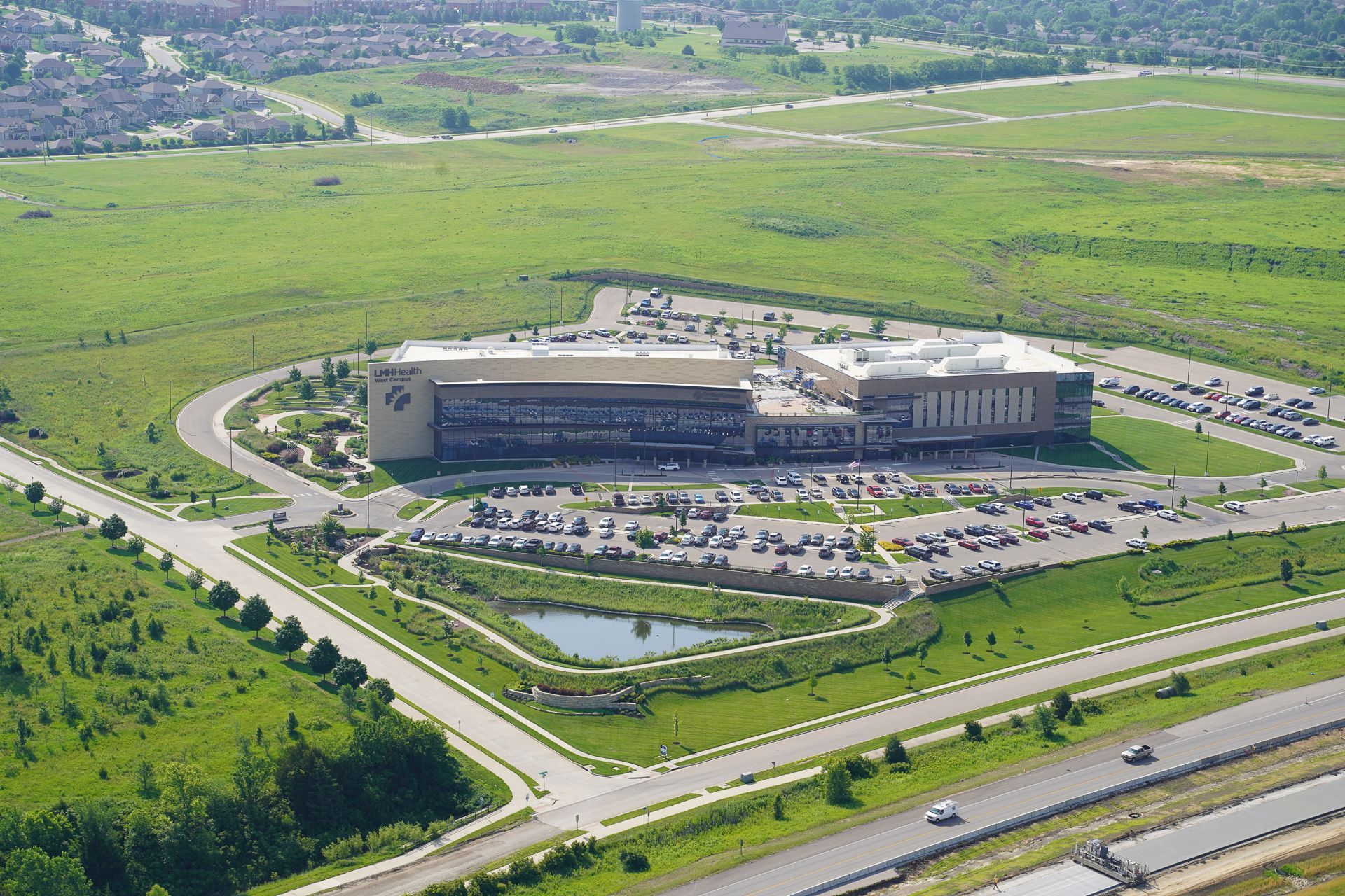 An aerial view of a large building in the middle of a field