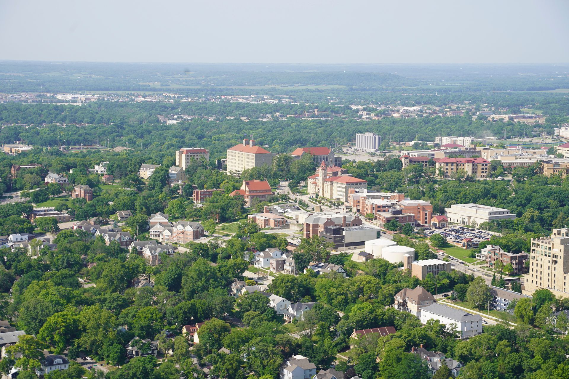 An aerial view of a city surrounded by trees and buildings