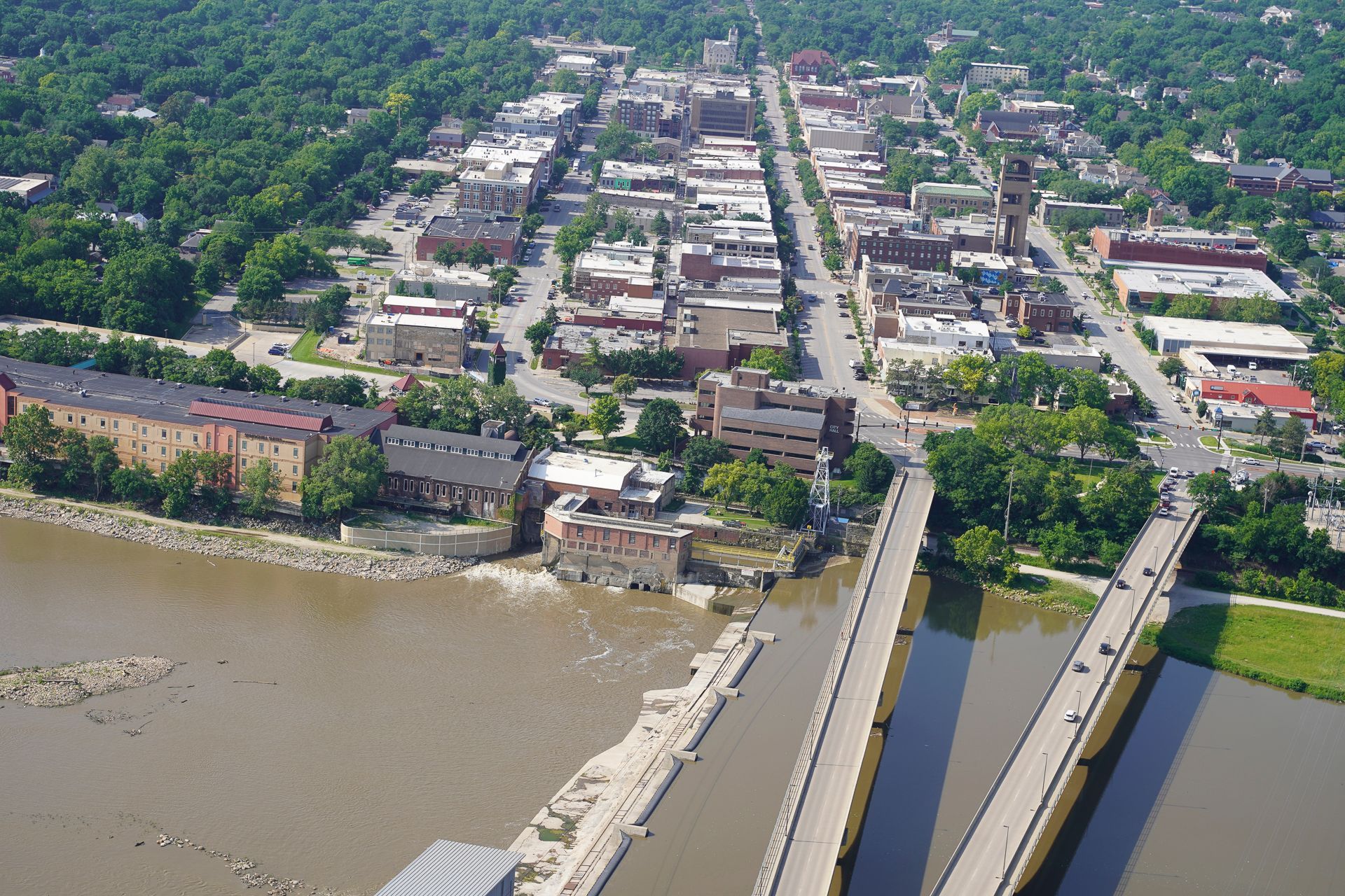 An aerial view of a city with a bridge over a river