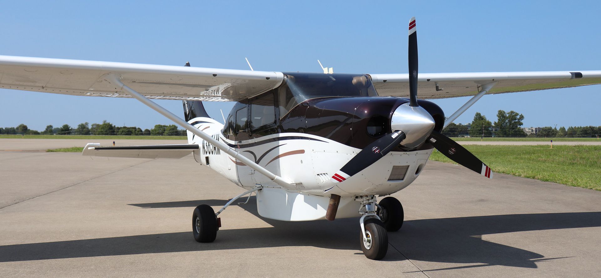 A small propeller plane is parked on a runway