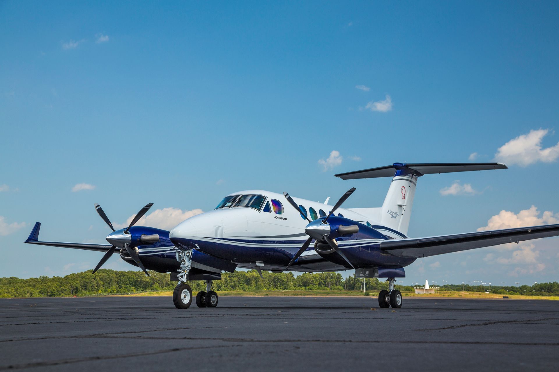 A small propeller plane is parked on a runway