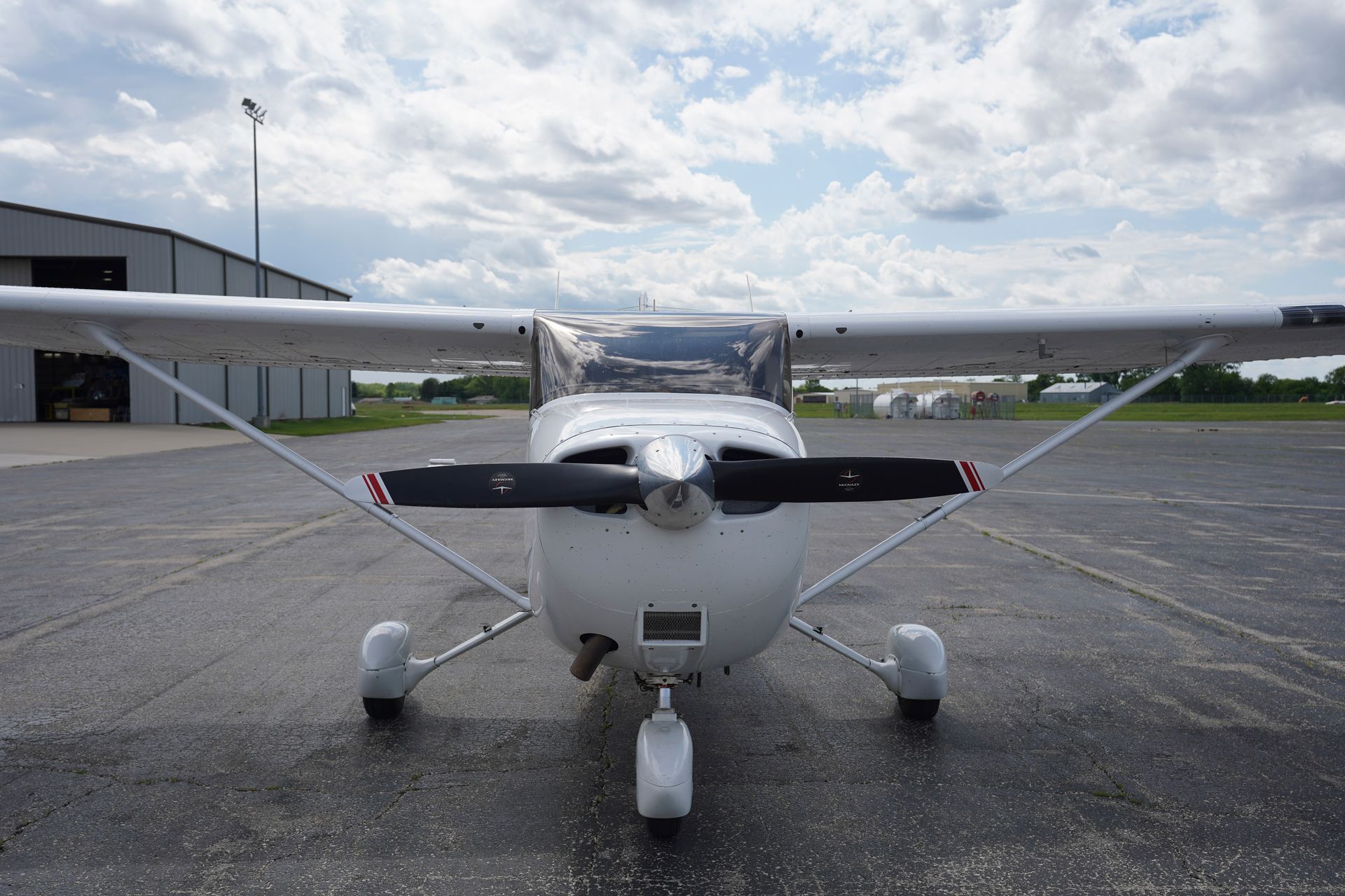 A small propeller plane is parked on a runway