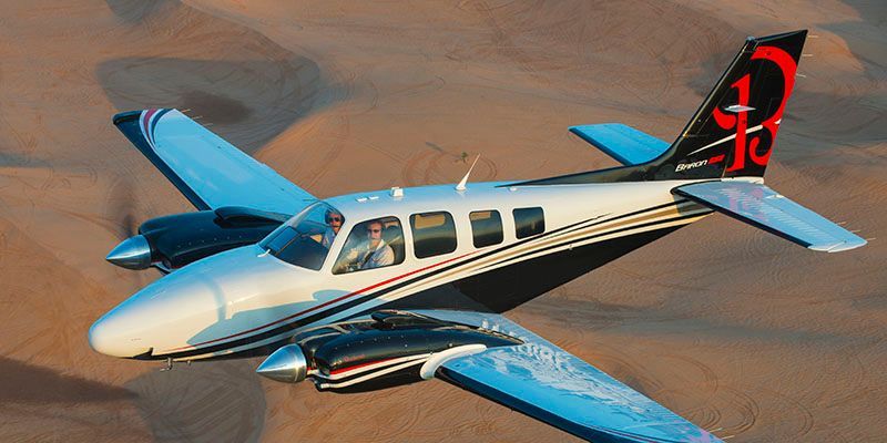 A small propeller plane is sitting on a runway.