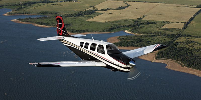 A small propeller plane is parked on a runway