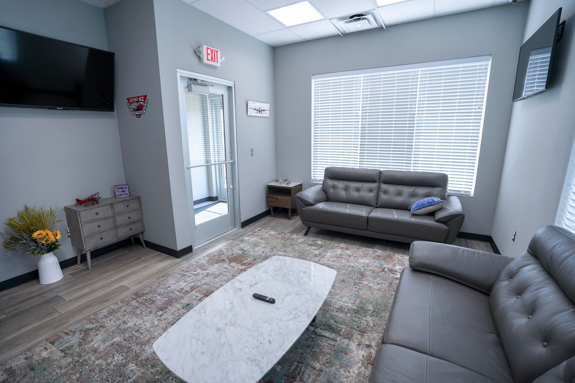 A living room with a couch , coffee table , and television.