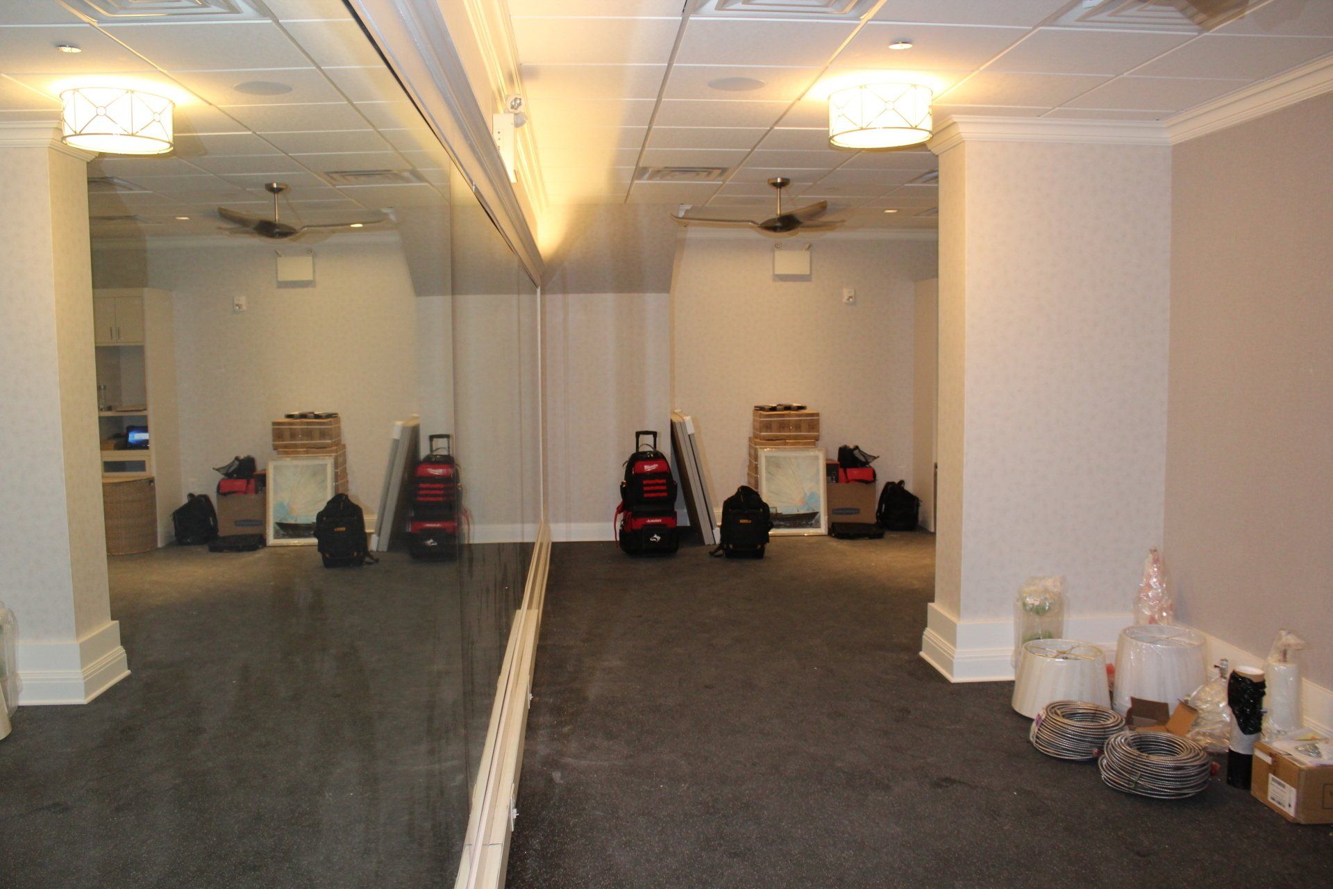 Gym construction progress with equipment installation and carpeting at The Reeds at Shelter Haven.