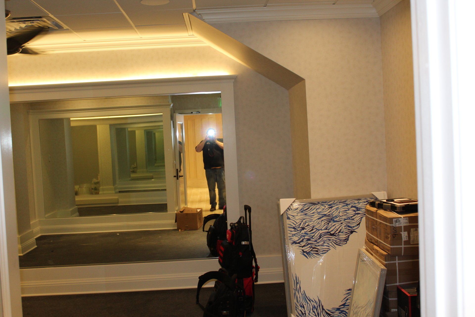 Renovated hallway with mirrors and gym equipment setup at The Reeds at Shelter Haven fitness center.