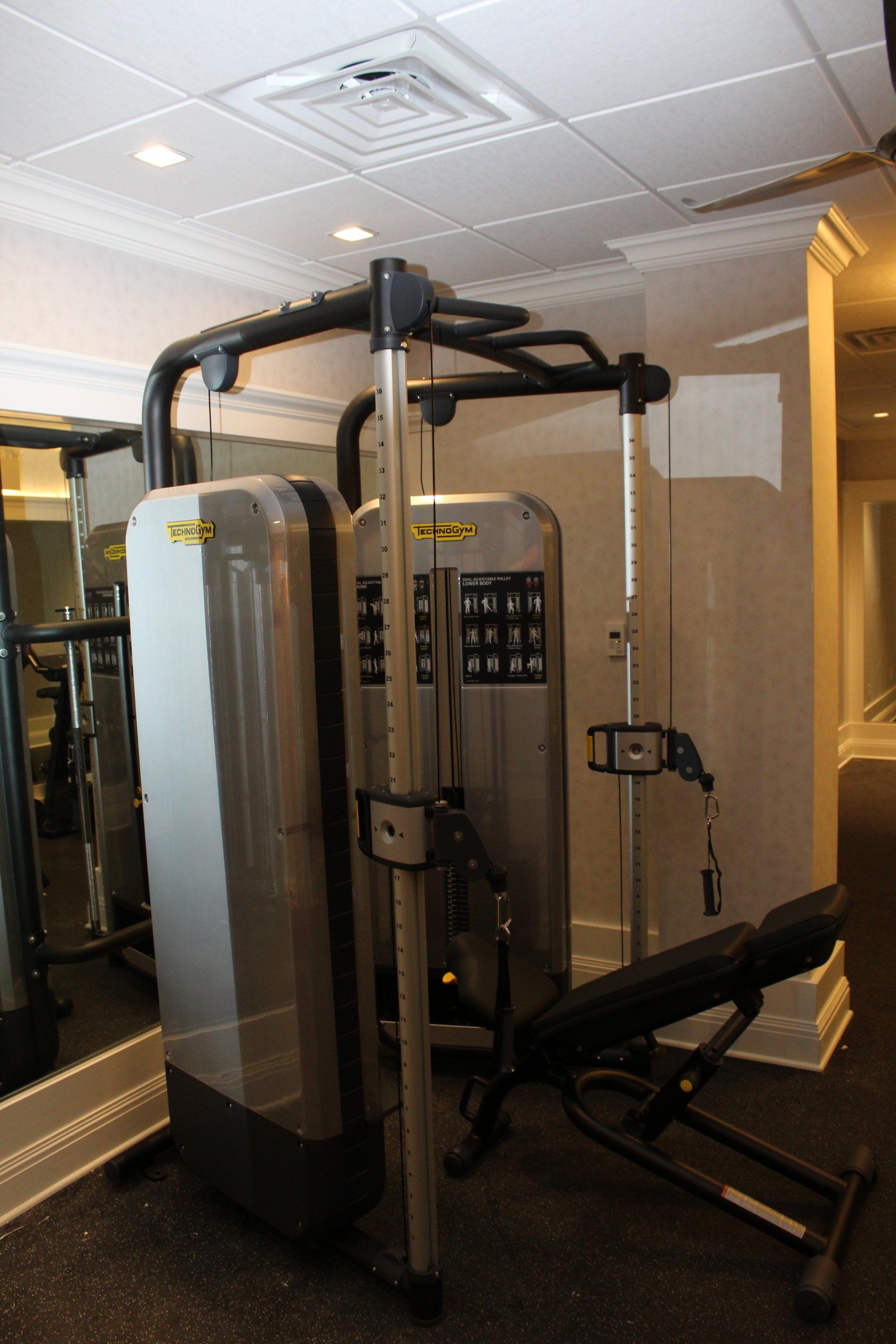 Strength training machine and weight equipment inside The Reeds at Shelter Haven fitness room.
