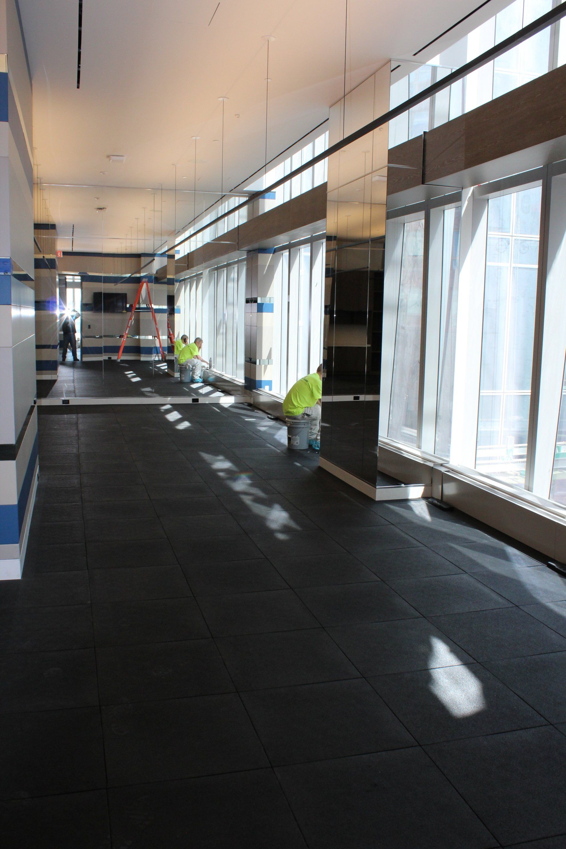 Workers finishing modern interior at One Manhattan Square.