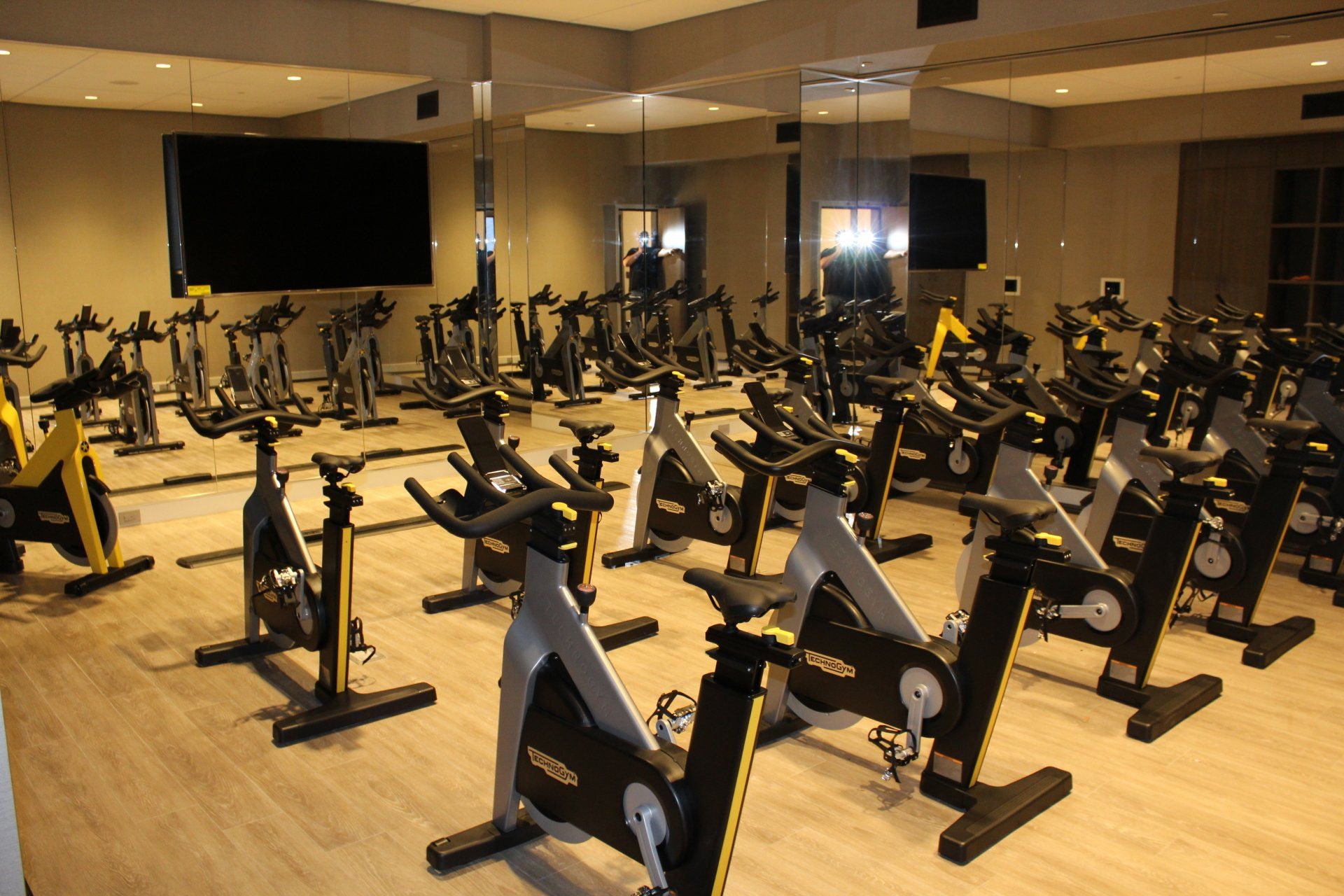 Indoor cycling studio with rows of stationary bikes at One Manhattan Square.