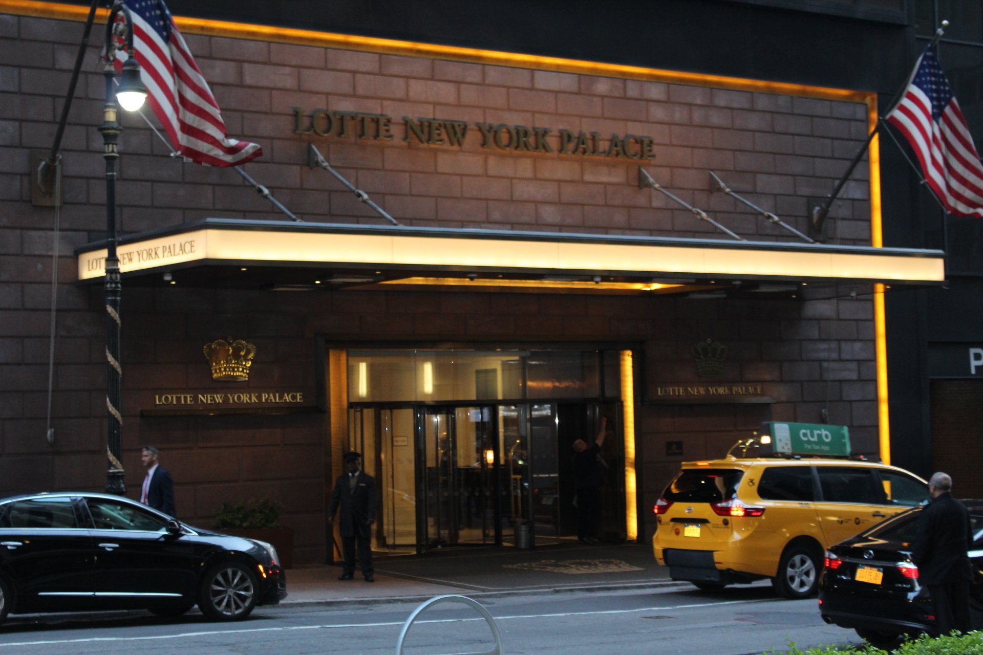Entrance of Lotte New York Palace hotel with yellow taxi in New York City