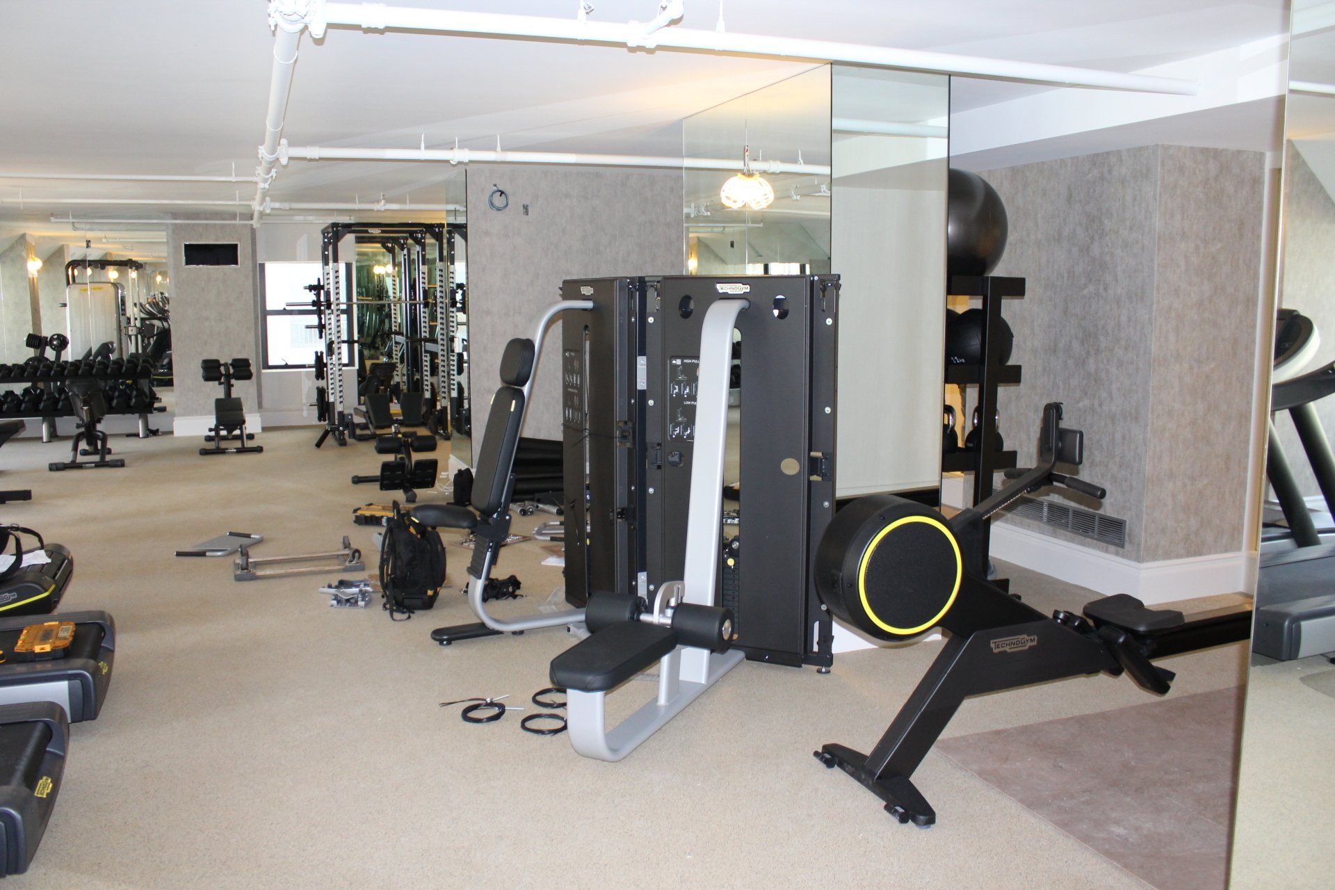 Bright fitness room with multiple machines at Lotte New York Palace.
