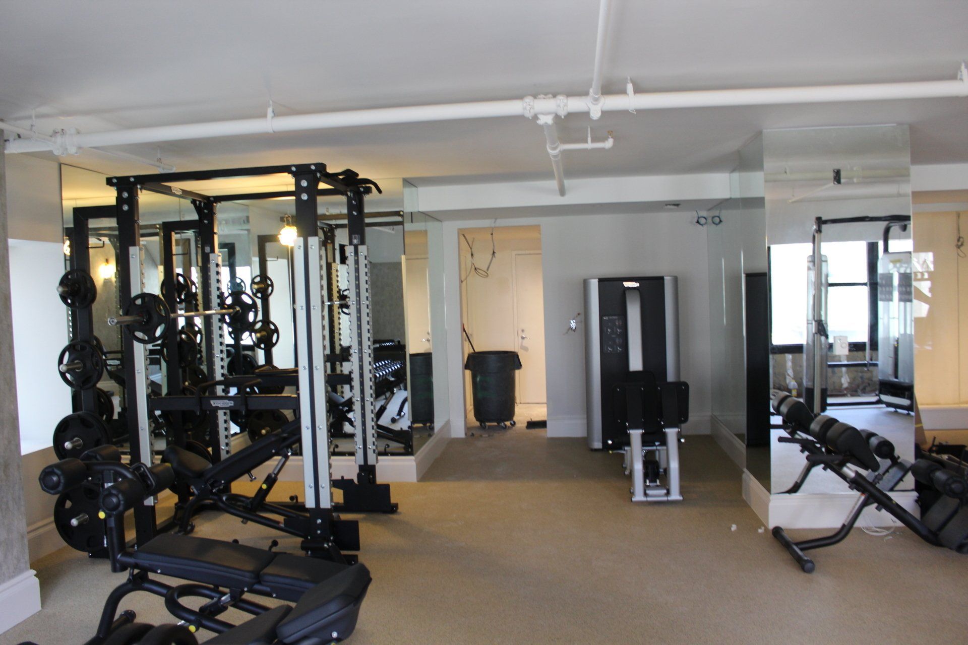 Strength training machines and free weights in Lotte New York Palace hotel gym.
