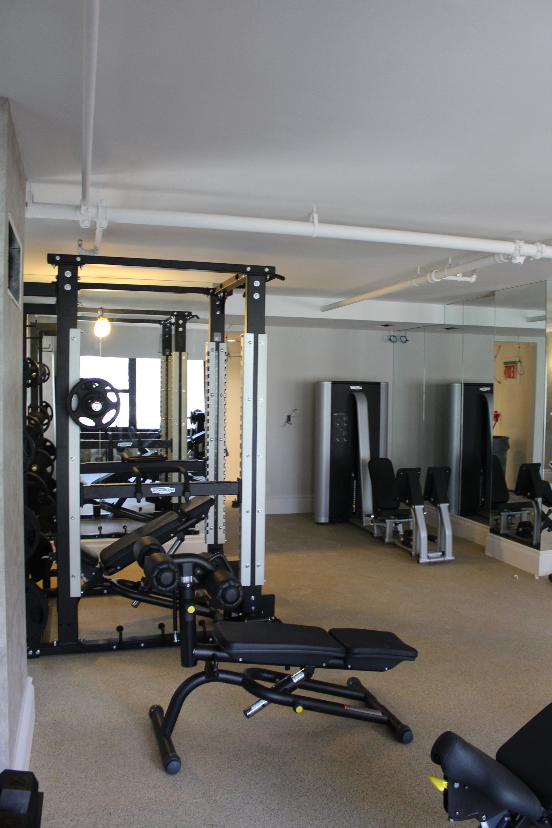 Weightlifting station with racks and equipment at Lotte New York Palace fitness center.