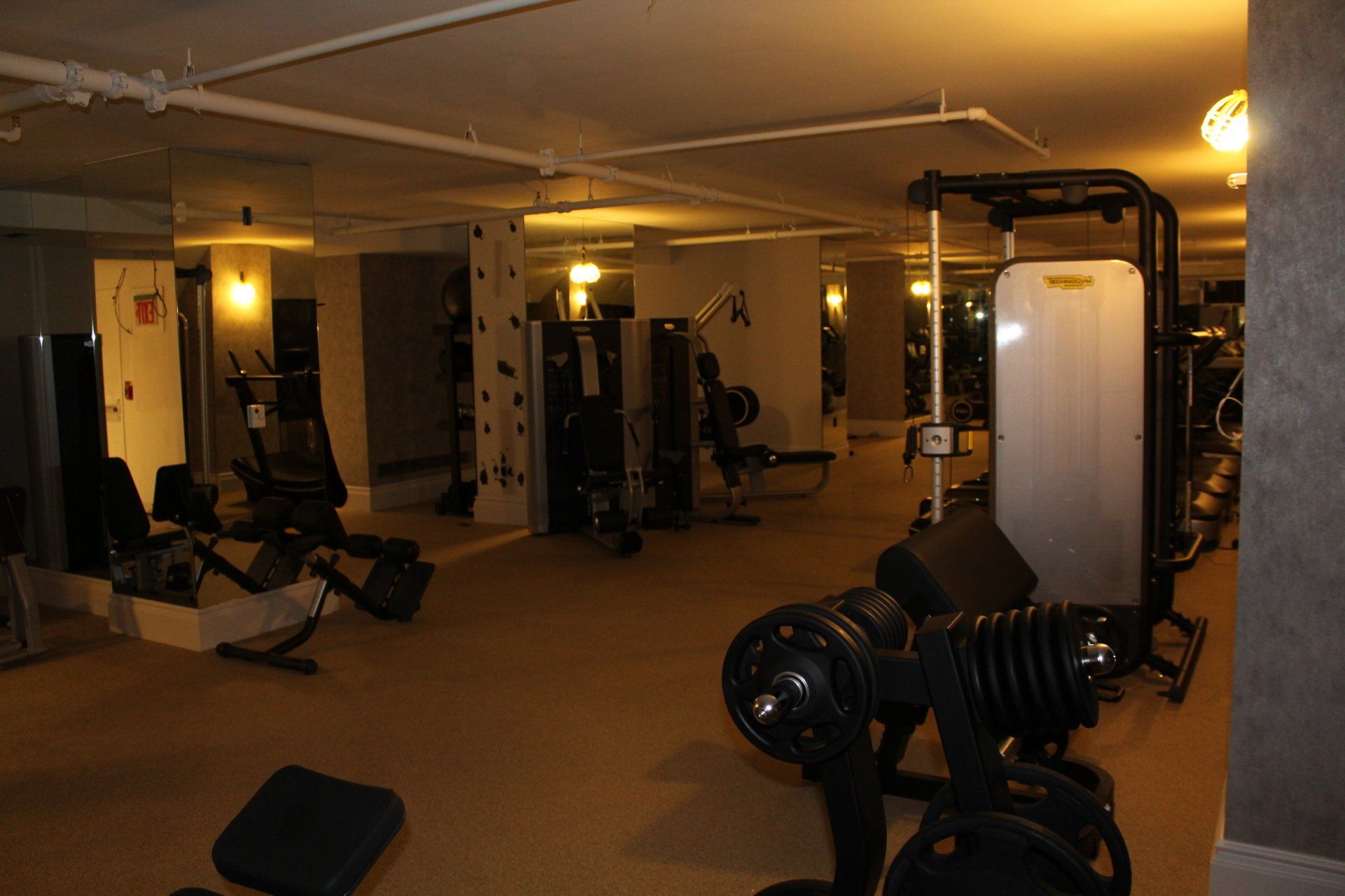 Strength training machines and free weights in hotel fitness room