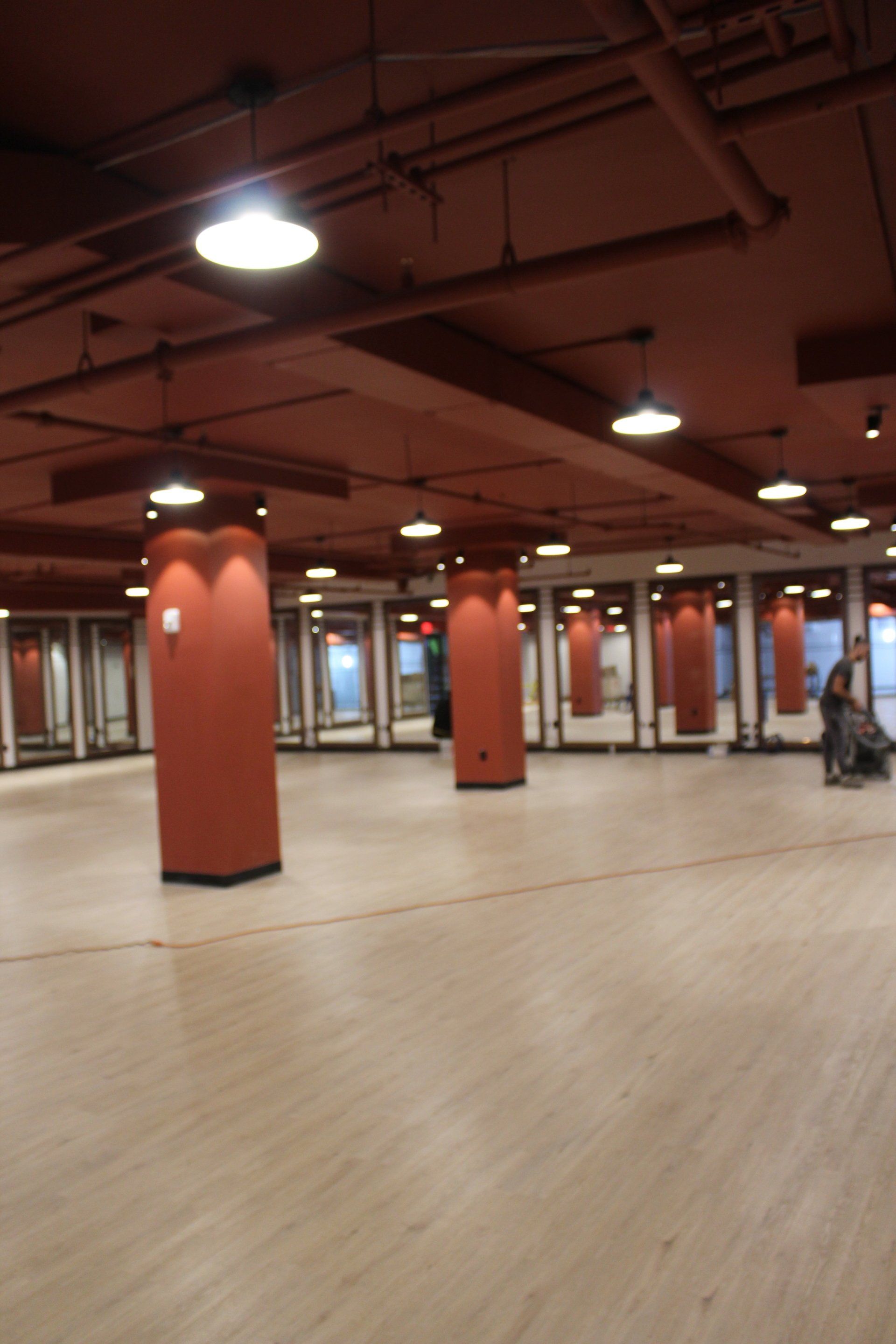 Interior of Twenty Exchange Place with red pillars and open floor space.