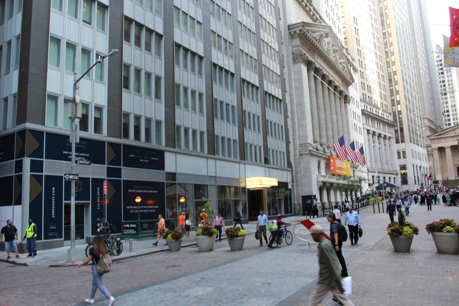 Exterior of Twenty Exchange Place building with busy street in New York City.