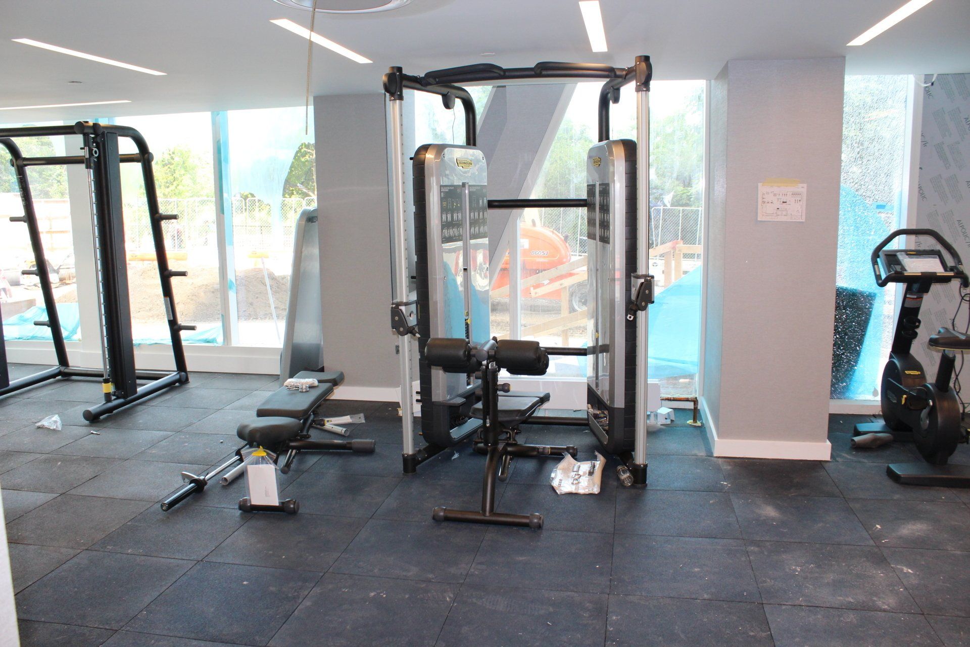 Strength training equipment and weights in Quay Tower gym with natural light.