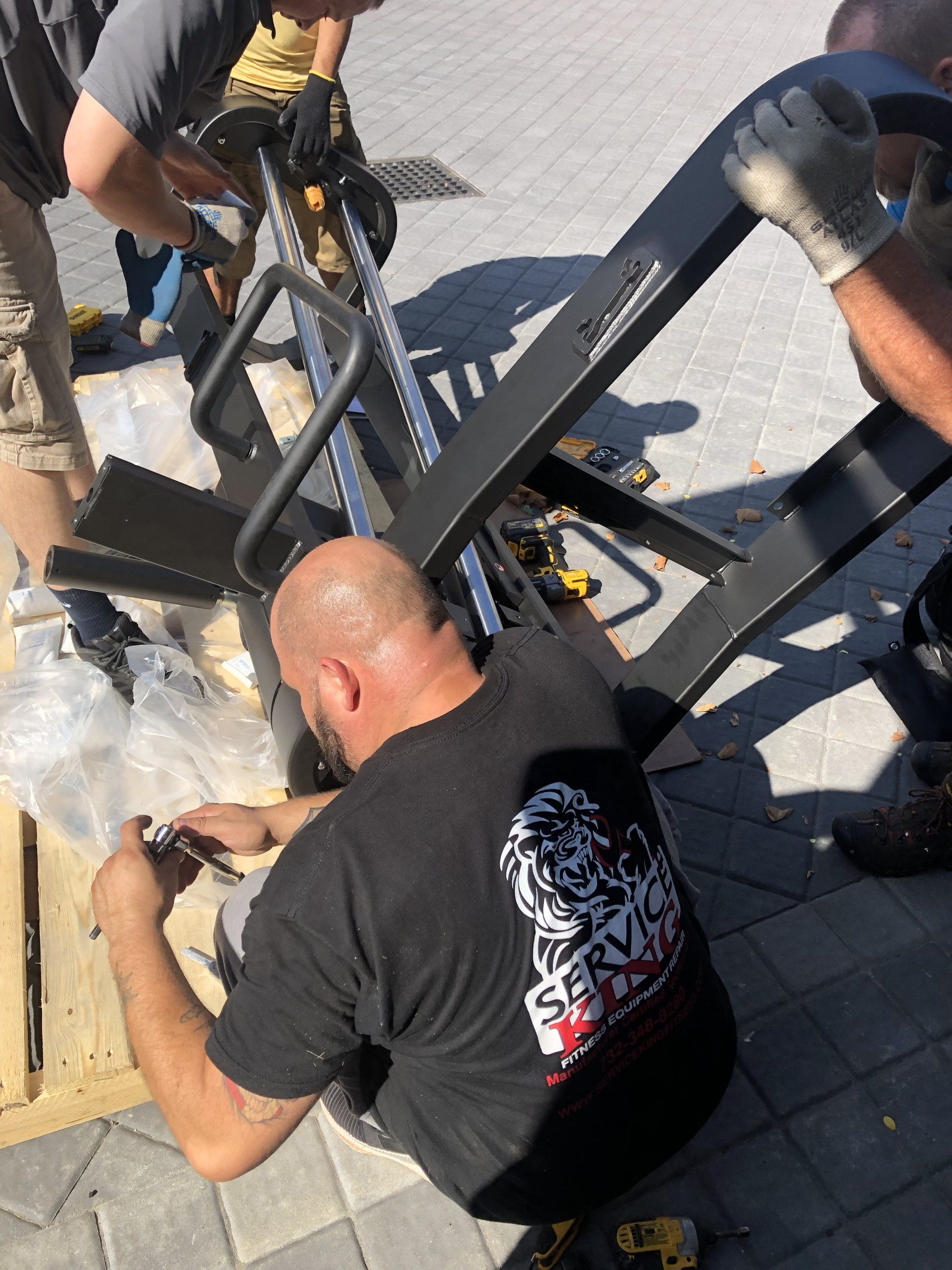 Close-up of technician assembling gym equipment in Bridgehampton residential build.