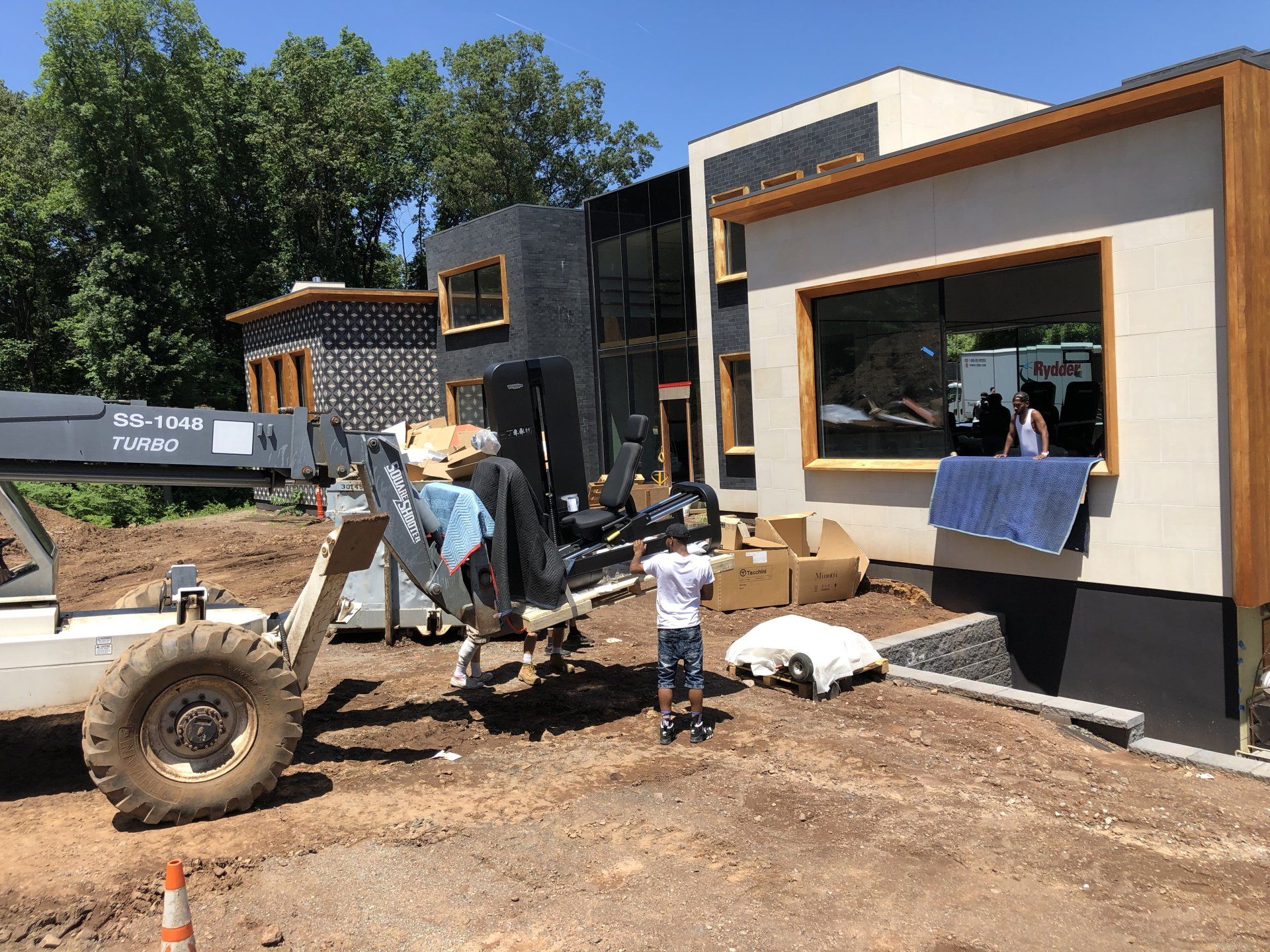 Workers and machinery completing framing and exterior work on Bernardsville residence.