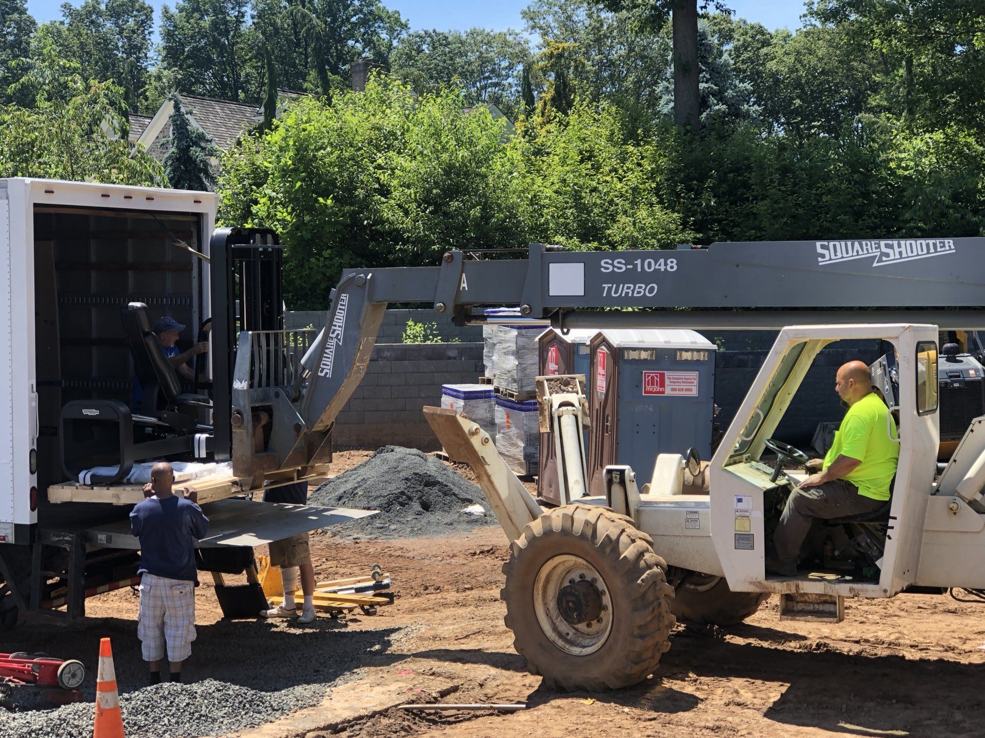 Forklift and crew unloading materials for Bernardsville residential home project.