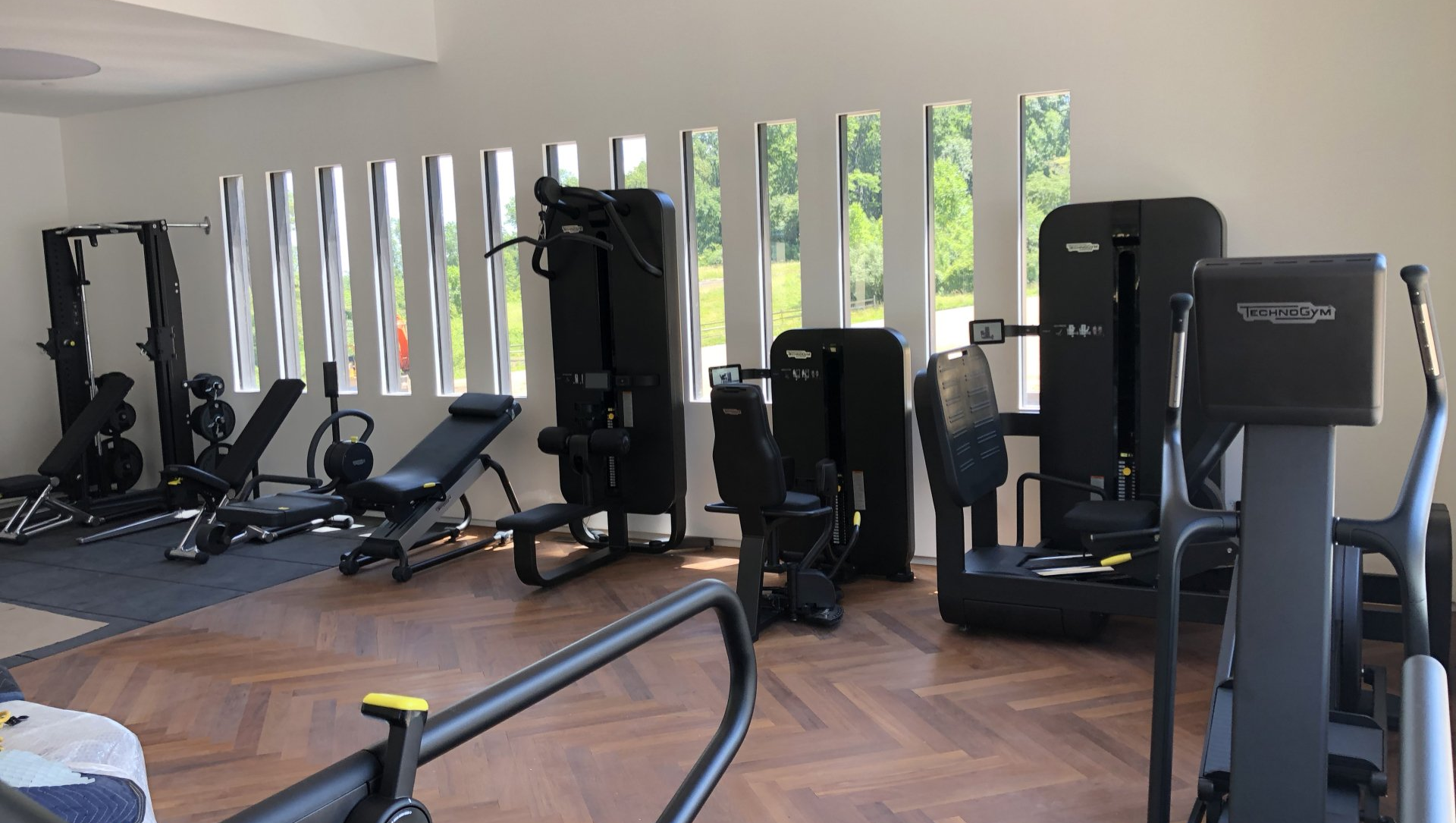 Modern home gym with strength training equipment in Bernardsville residence