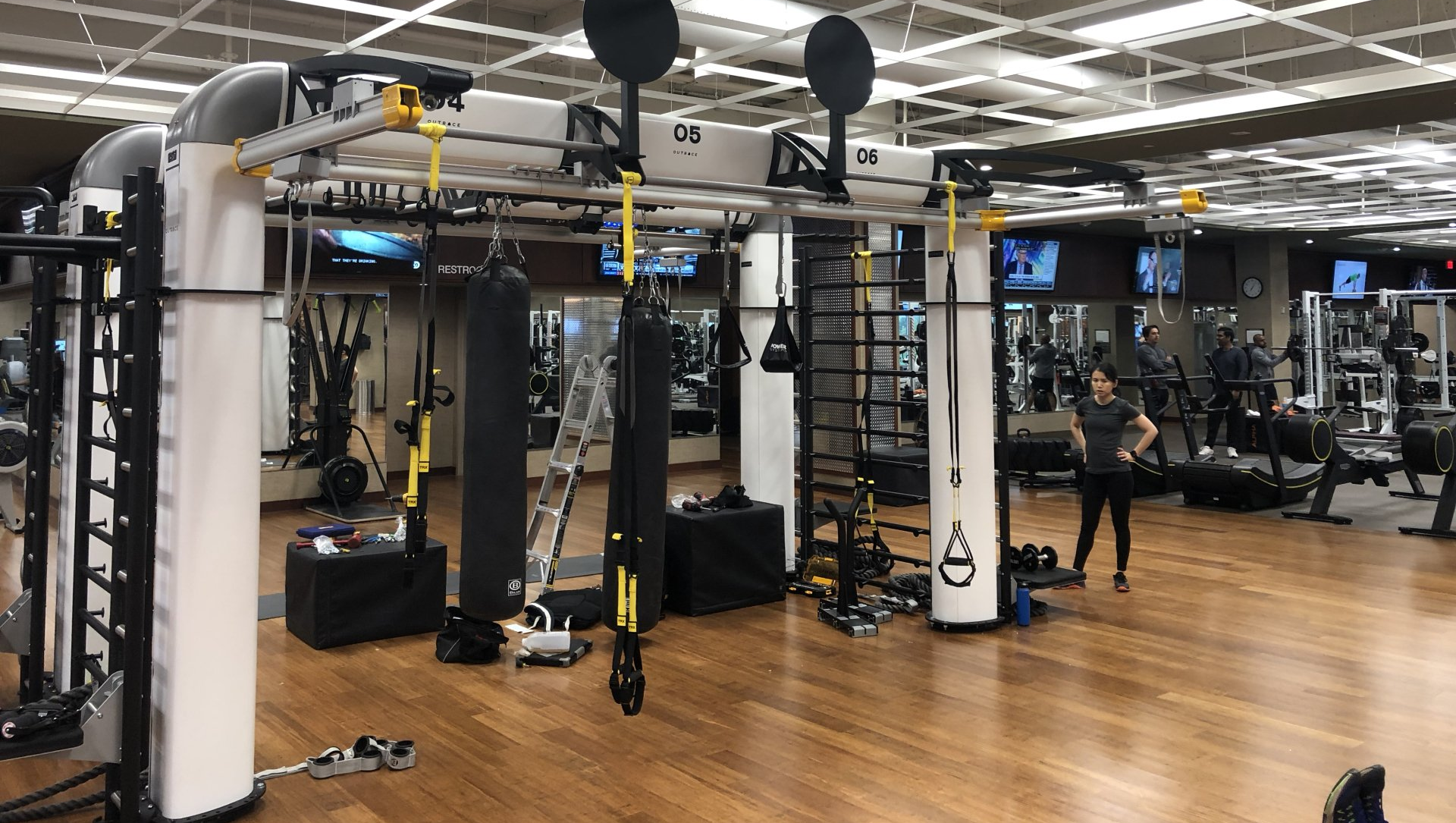 Lifetime Athletics gym with weight machines, cable stations, and open training area