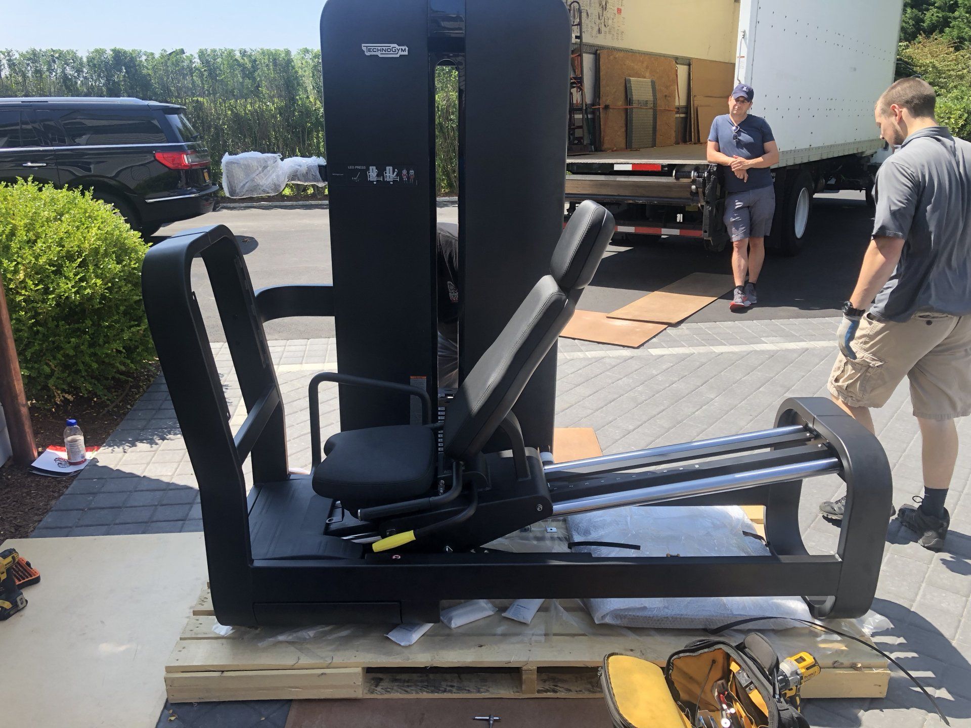 Gym equipment being delivered outside during Bridgehampton residential build.