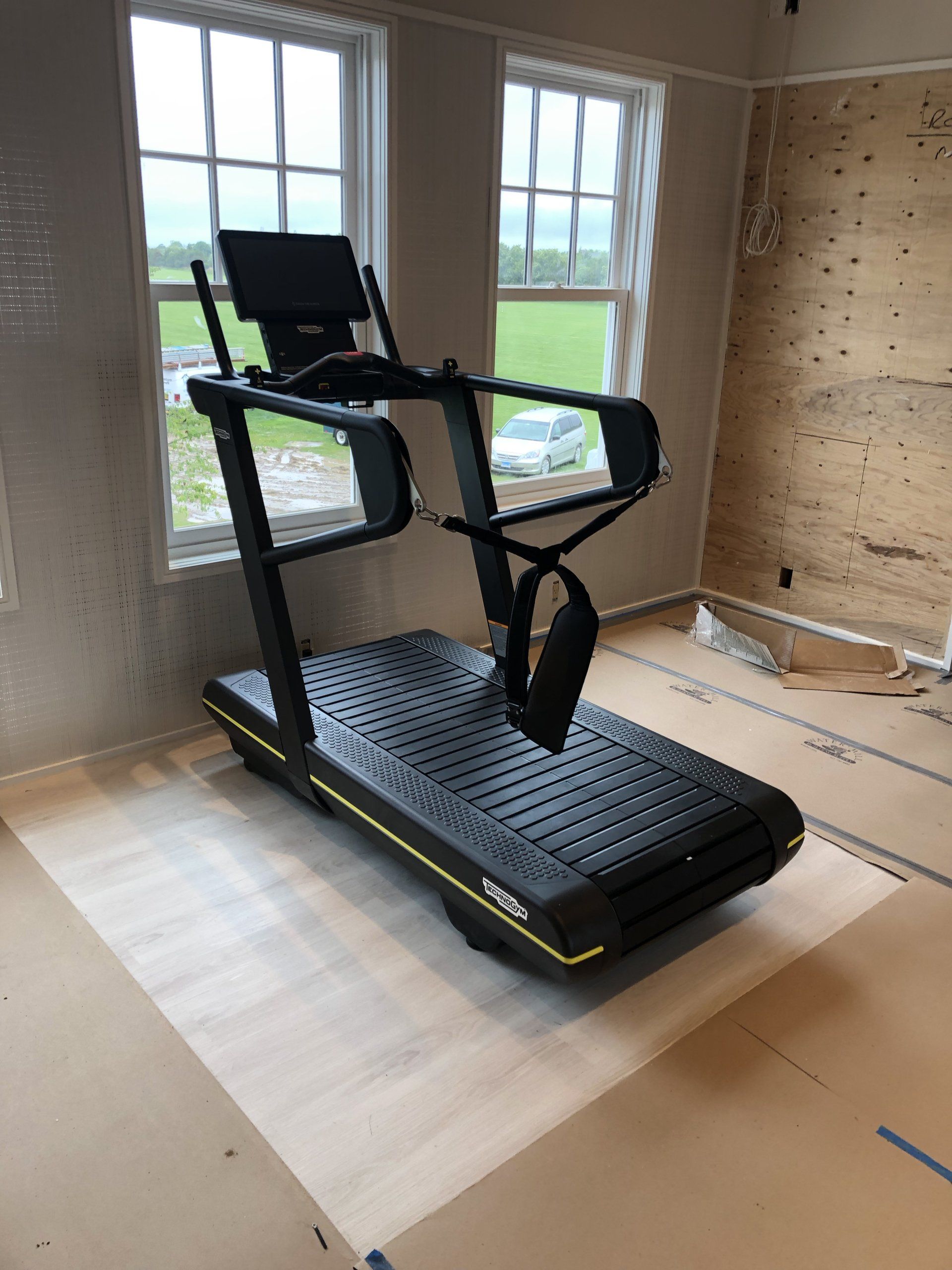 High-end treadmill positioned inside a modern home gym.