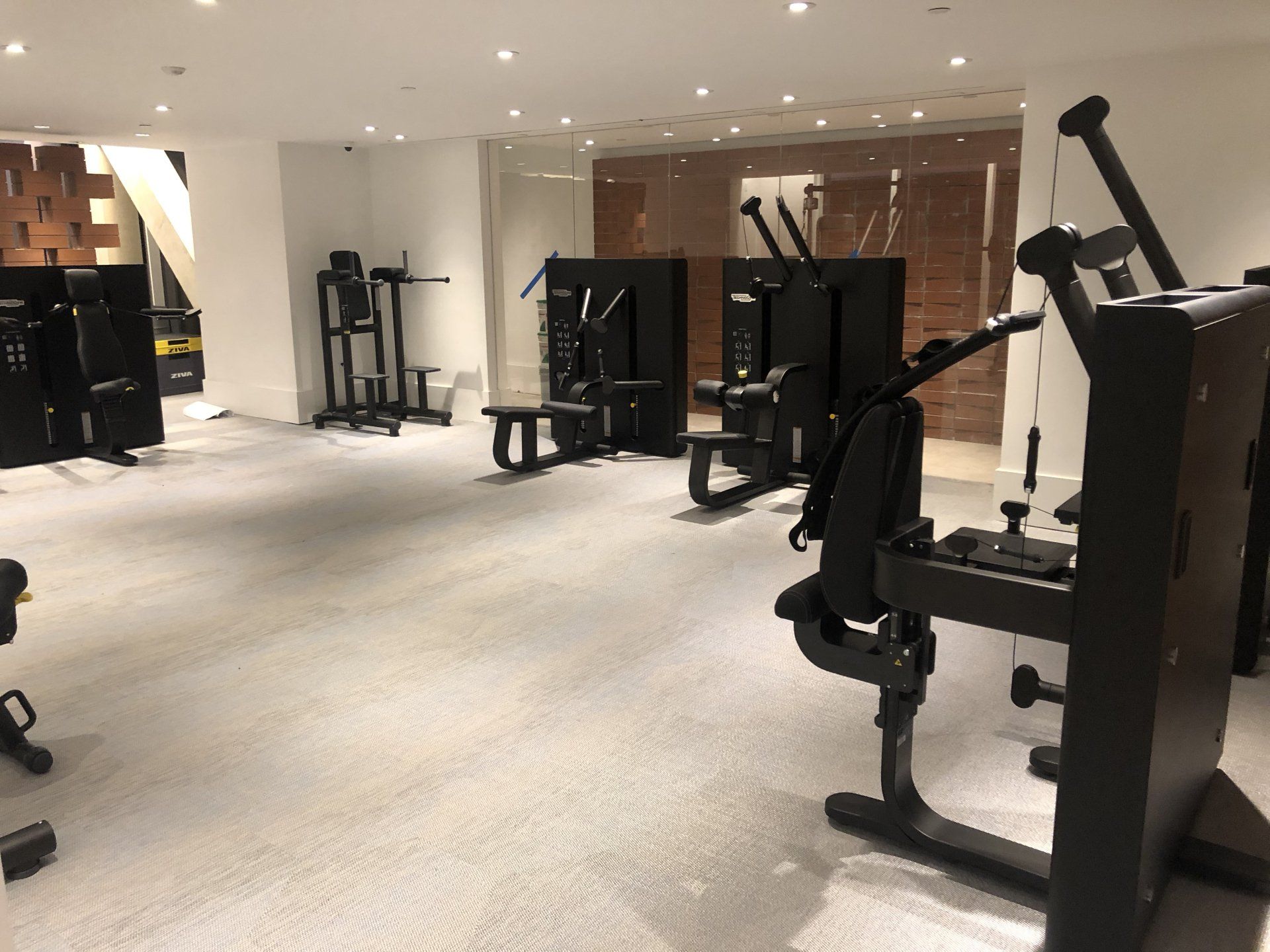 Spacious apartment fitness center with multiple workout stations.