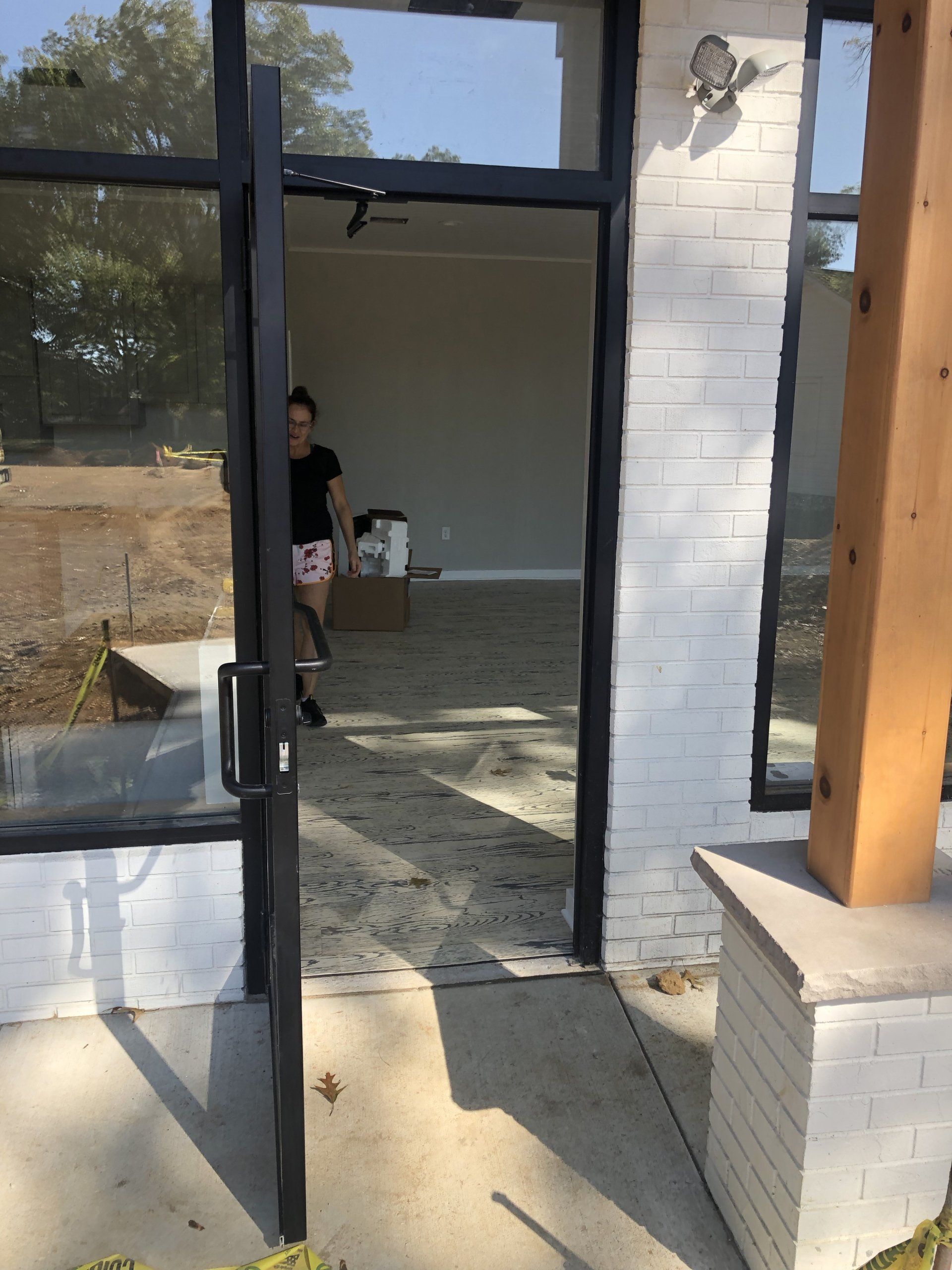 Entry view of Daily Fitness gym with staff preparing equipment installation.