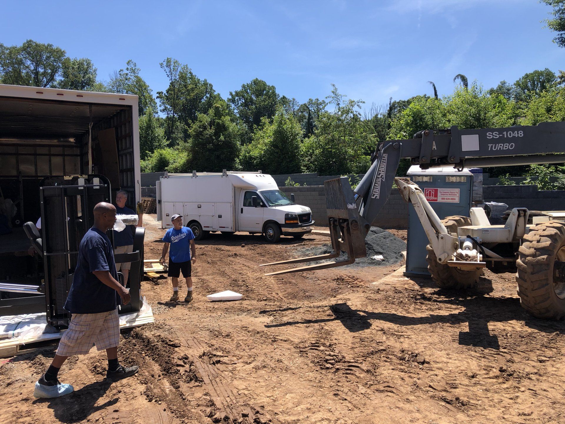 Construction crew and machinery at Bernardsville custom residential build site