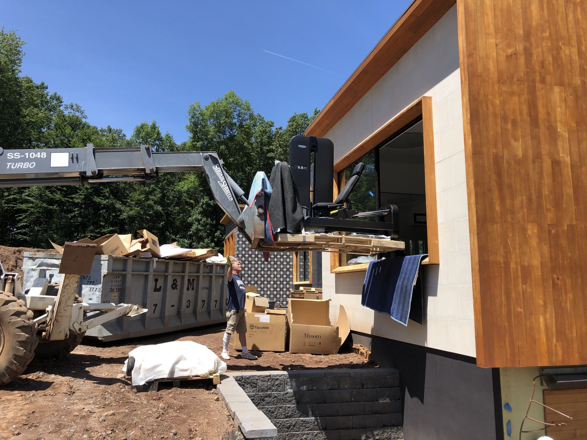 Bernardsville residential build with modern exterior panels and construction equipment on site.