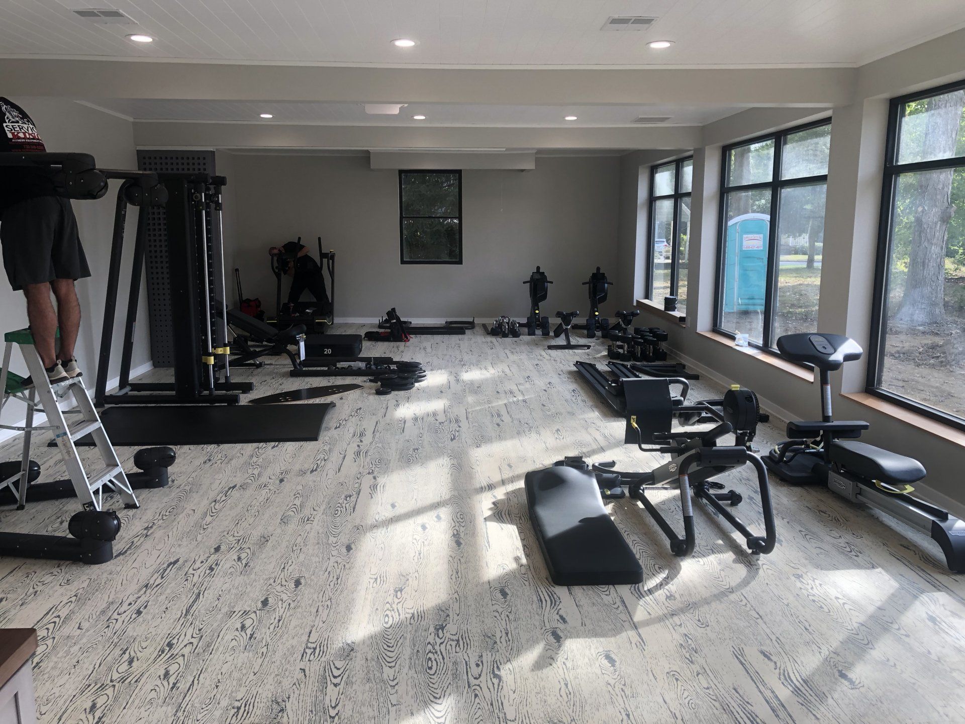 Spacious fitness room at Daily Fitness with new strength training machines.