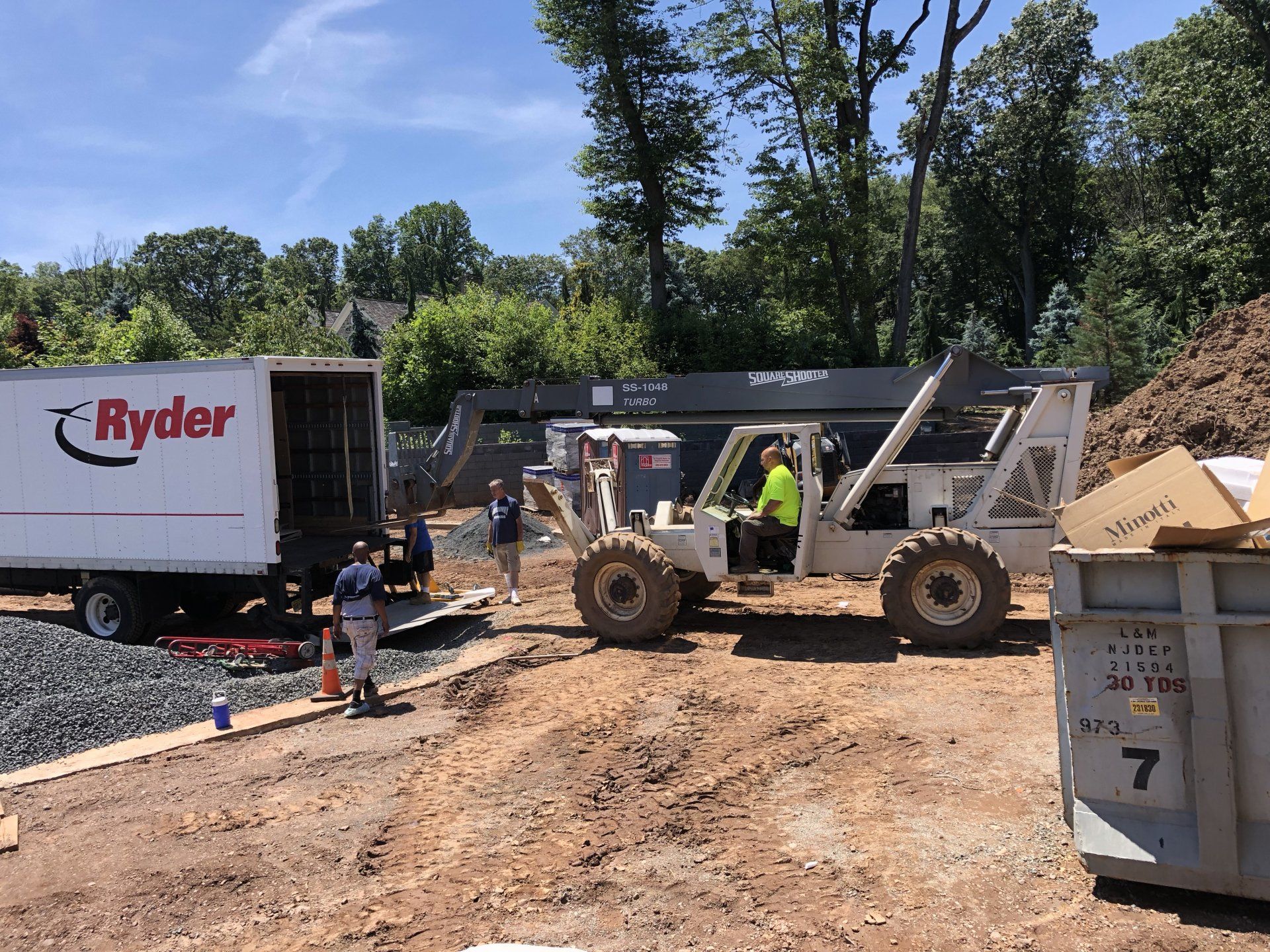 Workers and heavy equipment on Bernardsville residential construction site