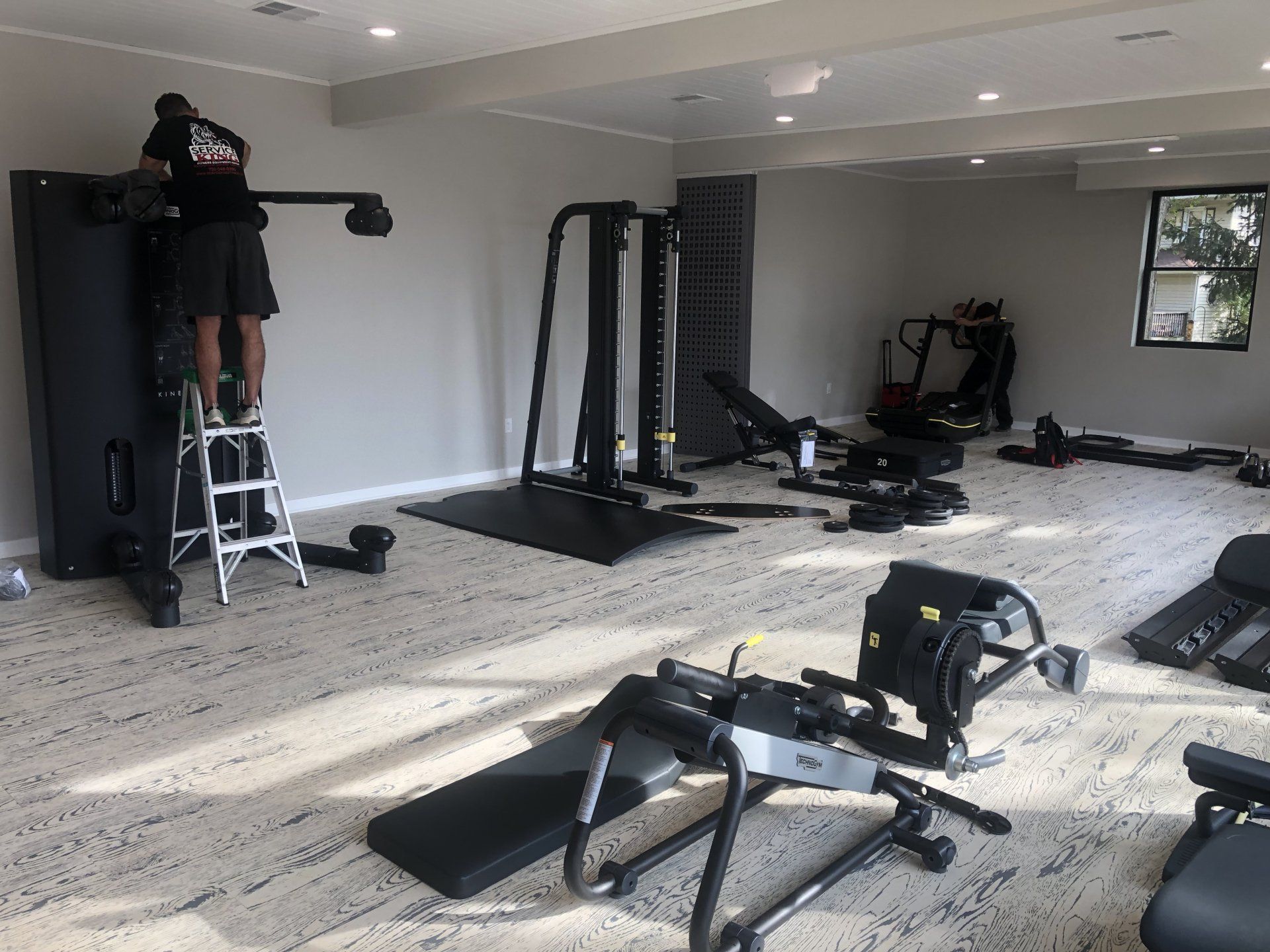 Gym equipment installation in progress inside Daily Fitness training room.
