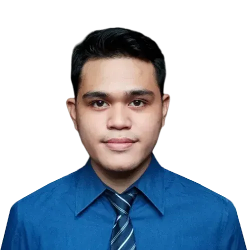 A man in a blue shirt and tie looks at the camera