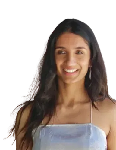 A woman with long hair is smiling and wearing a blue top.