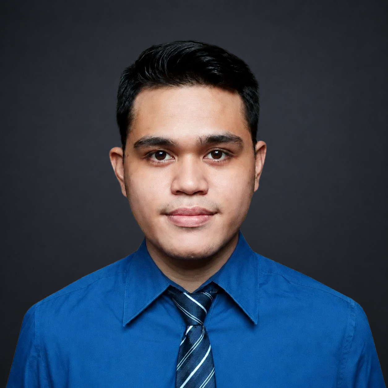 Man in blue shirt and tie, looking at the camera, professional headshot.